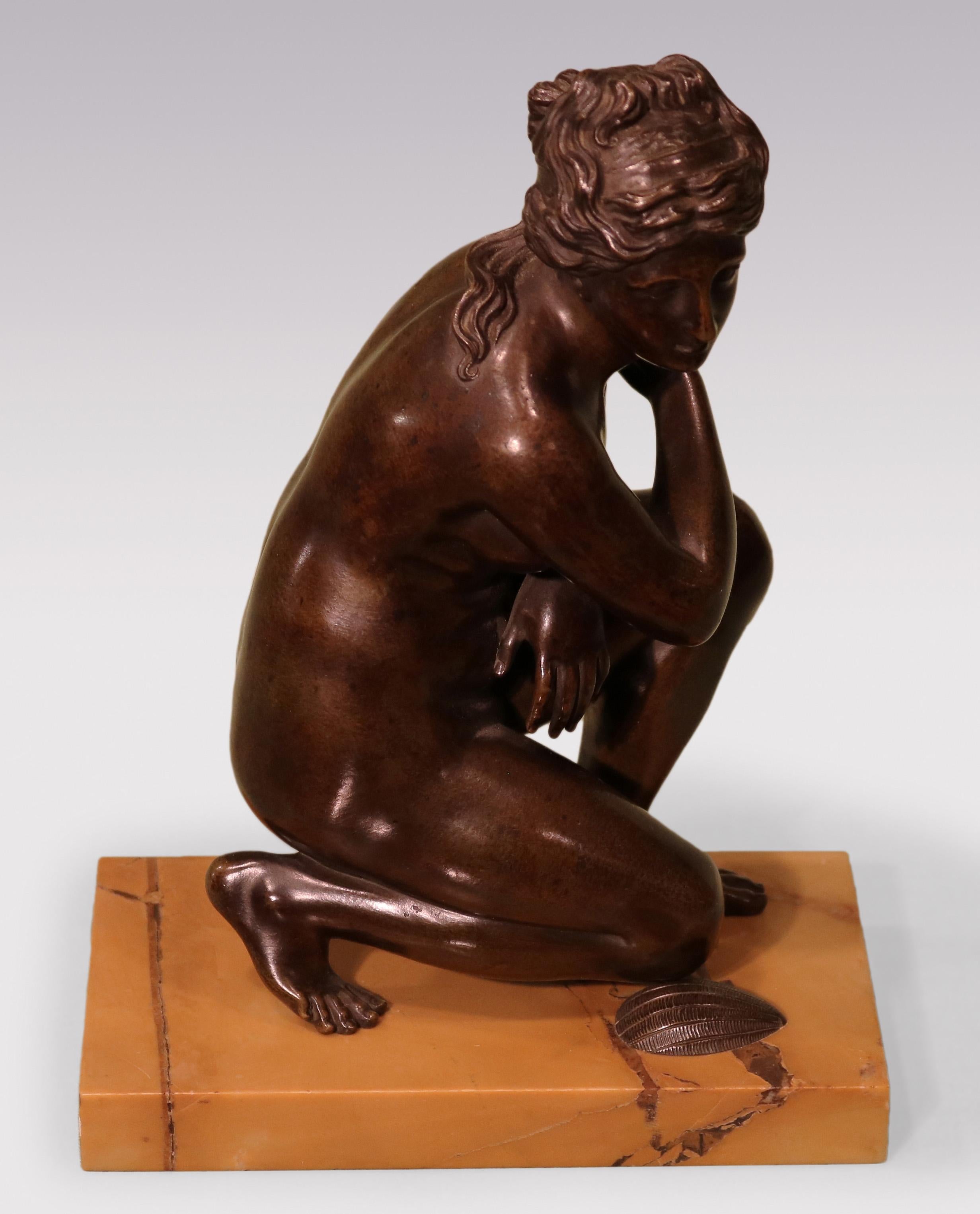 A well-cast early 19th Century bronze Model of crouching Venus kneeling on shell supported on Sienna marble base.