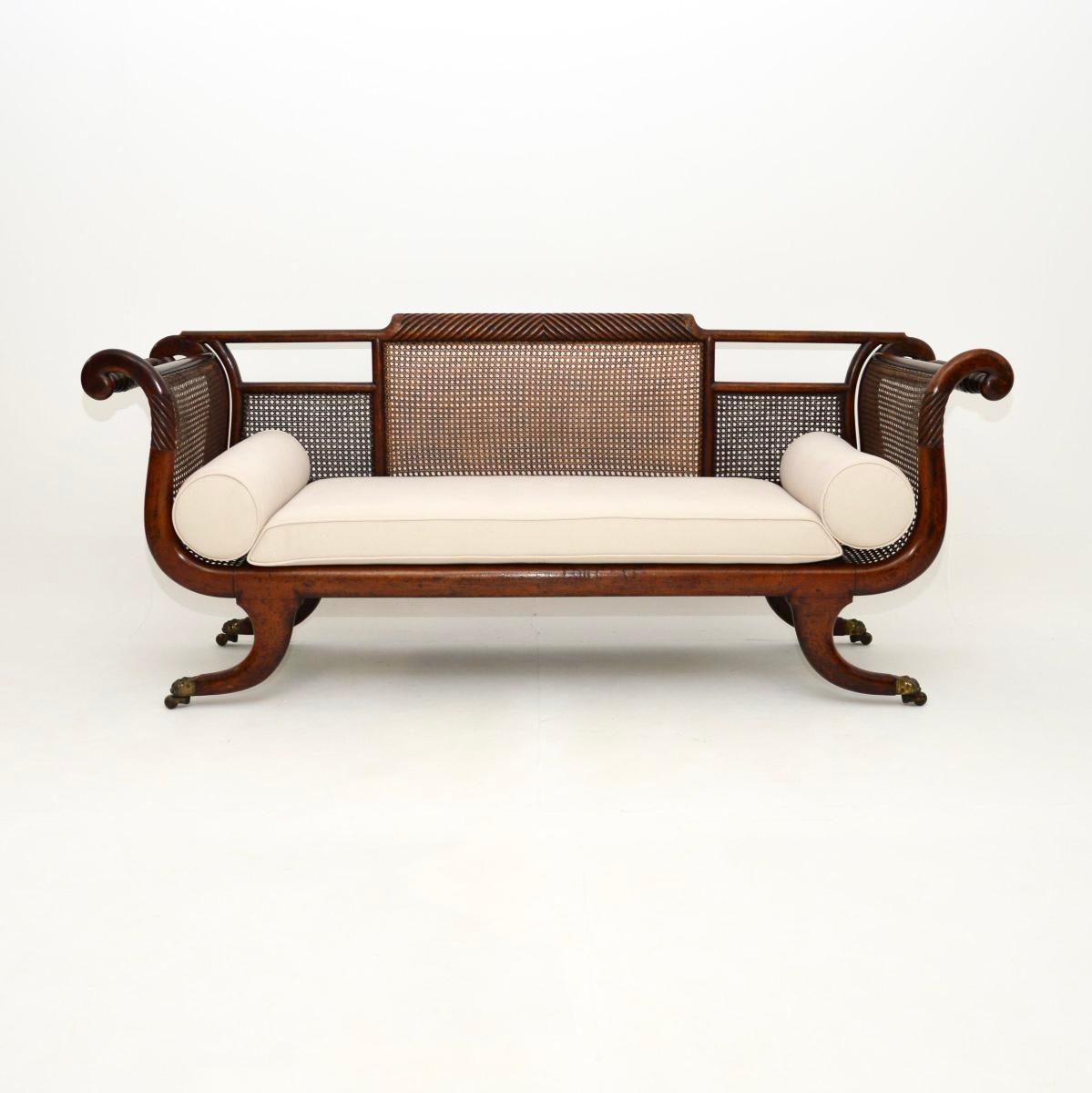 A wonderful original antique Regency period caned sofa. This was made in England, it dates from around the 1815-1830 period.

It is of superb quality, with a beautiful and impressive design. The ends are elegantly scrolled, this stands on lovely