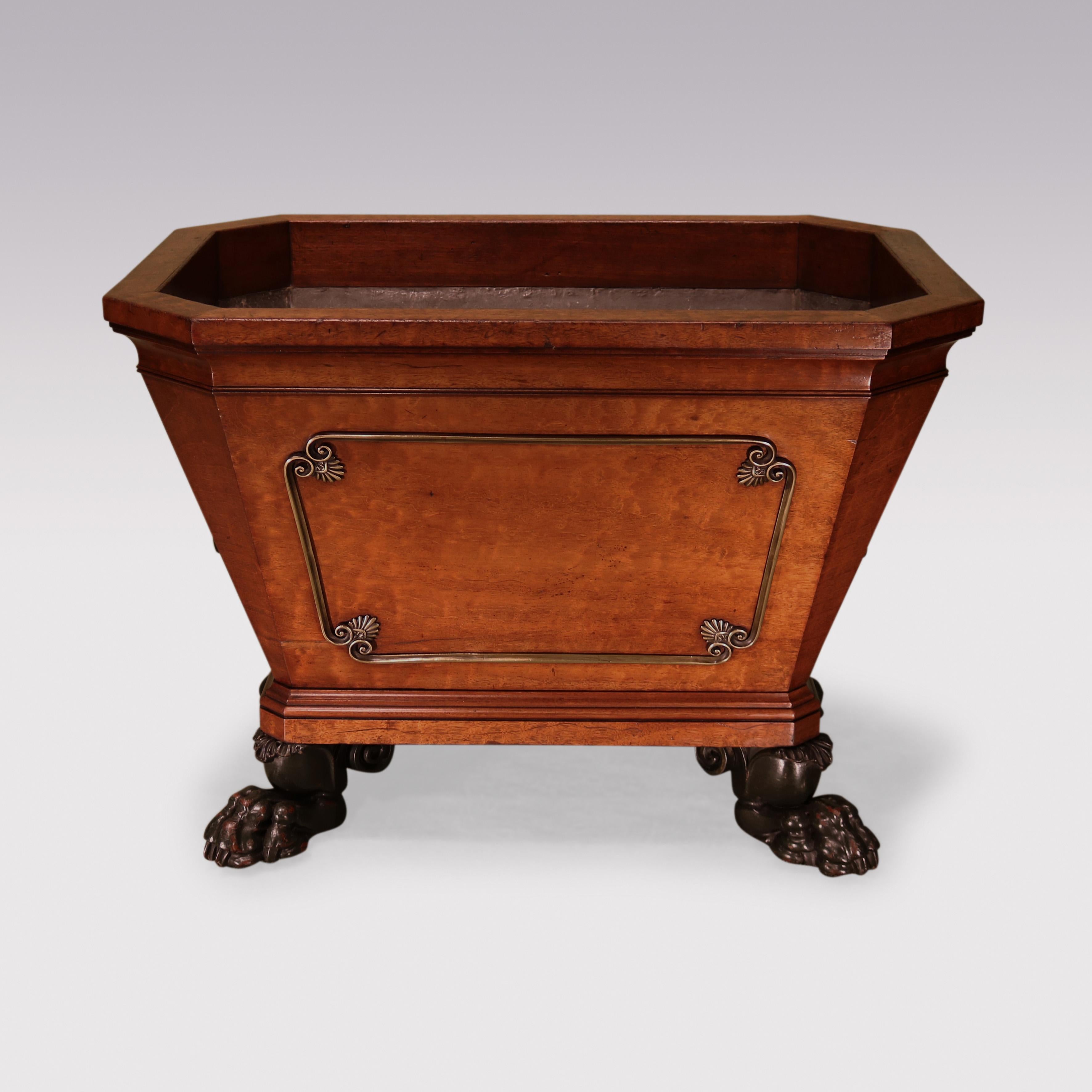 A fine quality early 19th Century Regency period plum-pudding mahogany Cellarette of sarcophagus shape with canted corners, having scrolled brass mounts with anthemion corners to the sides with bronze shell & acanthus handles, supported on bold