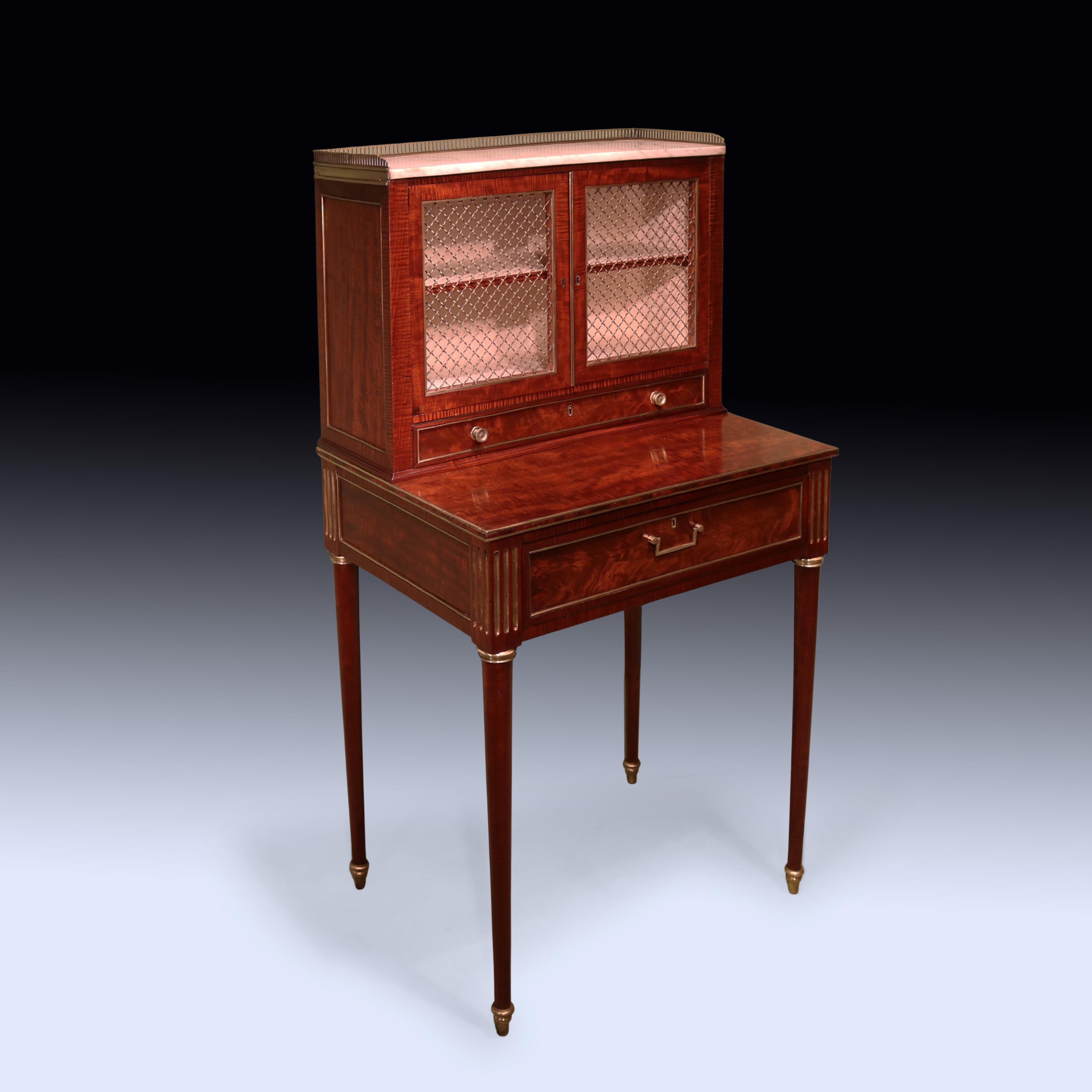 Una coppia di Bonheur du Jours in mogano e mogano a dorso di violino, risalenti all'inizio del XIX secolo, con piani in marmo gallerizzato in ottone sopra 2 porte a griglia in ottone e cassetto sottostante.  I pezzi, con modanature e rivestimenti in