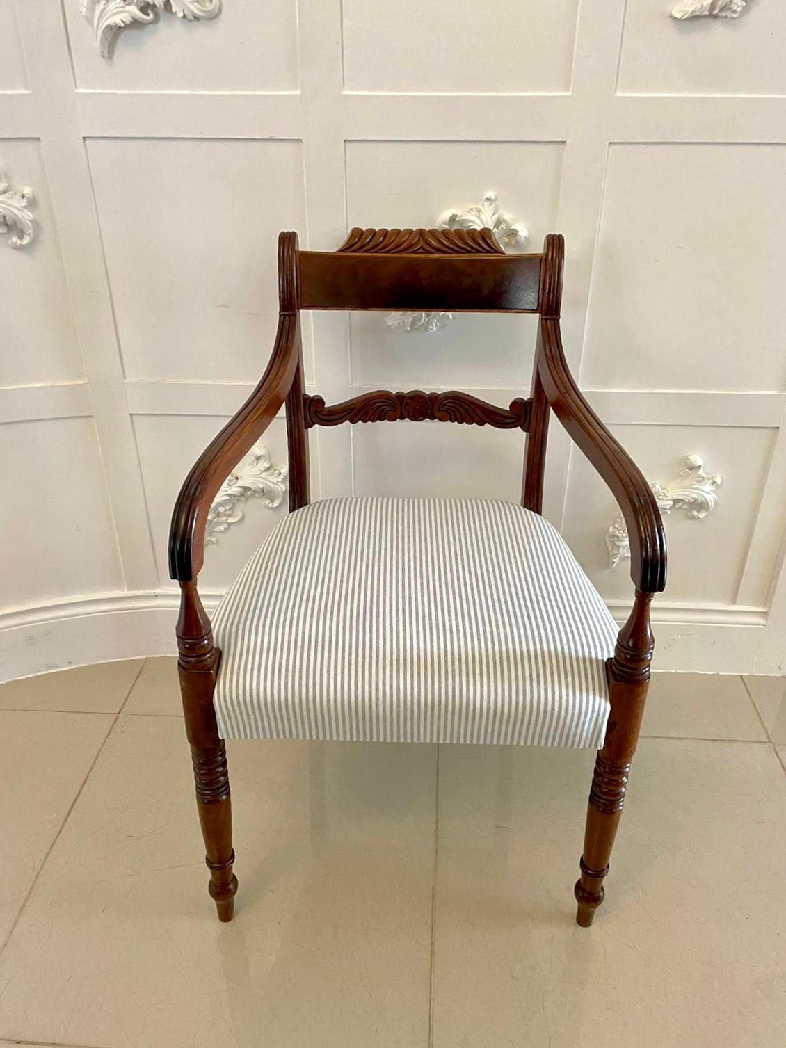 Antique Regency quality carved mahogany desk chair having a figured mahogany carved top rail, quality carved splat to the centre, shaped reeded open arms with turned supports, newly reupholstered seat in a quality fabric standing on elegant turned