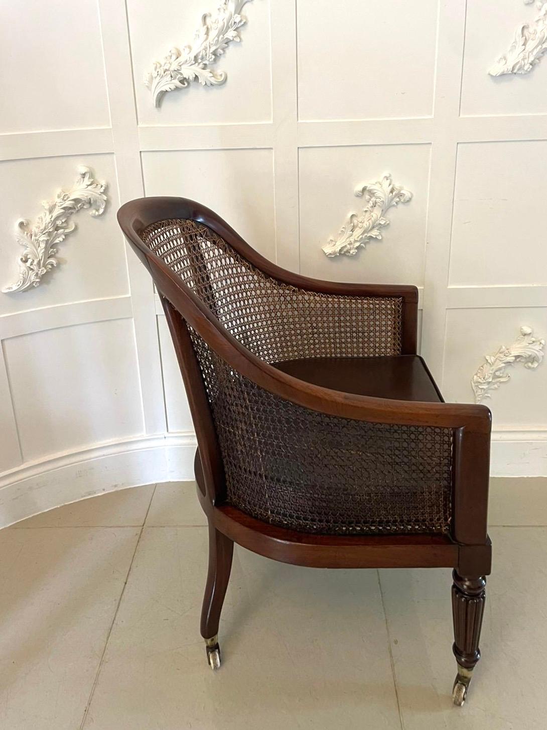 Antique Regency quality mahogany Bergere library armchair having a quality mahogany back caning in perfect condition, brown colour leather seat standing on lovely reeded tapering legs to the front and out swept back legs on original brass cup