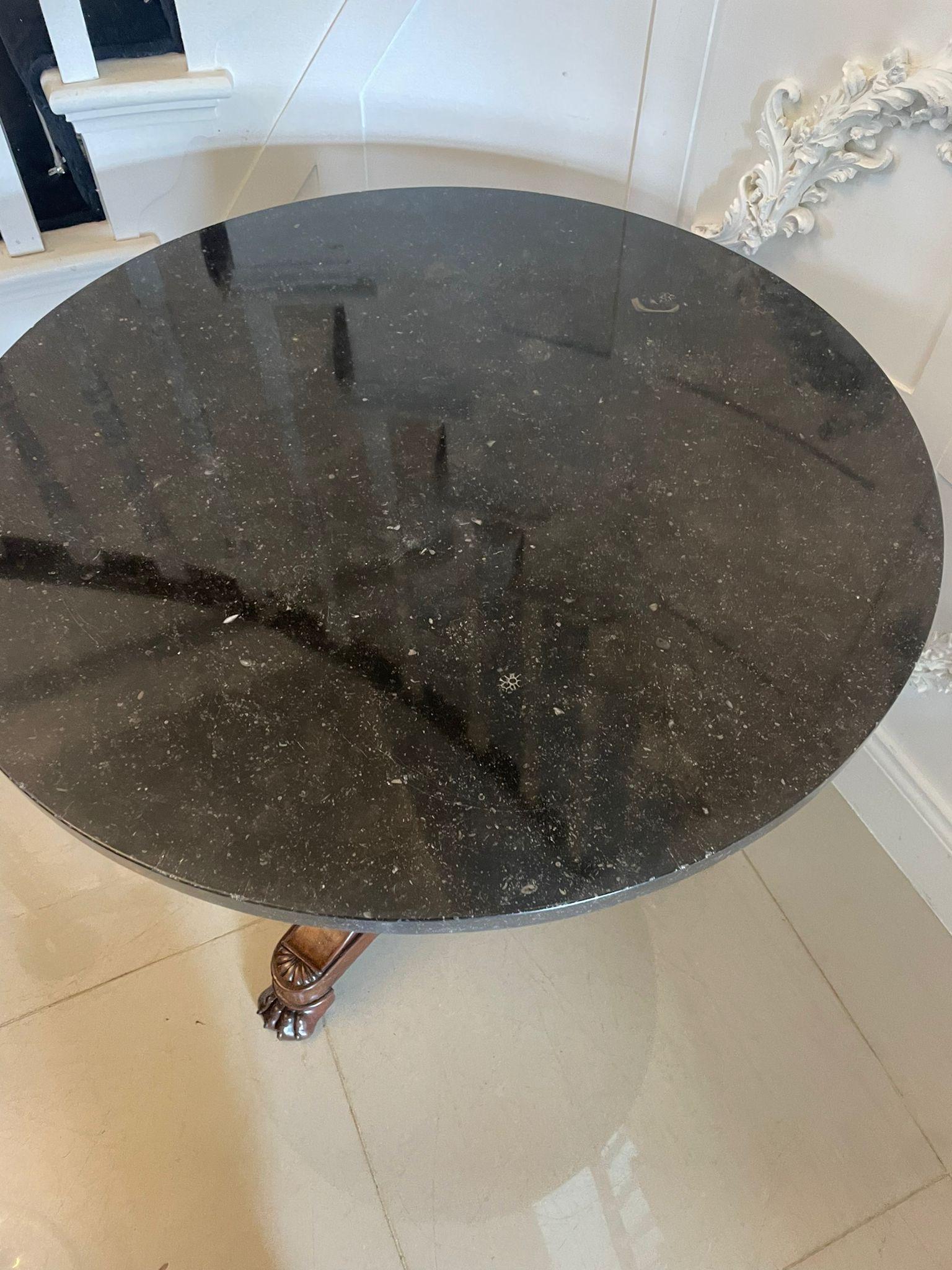 Antique Regency quality mahogany circular marble top centre/lamp table having a quality black marble circular top supported by a figured mahogany frieze and a hexagonal shaped pedestal column standing on a carved platform base with carved paw