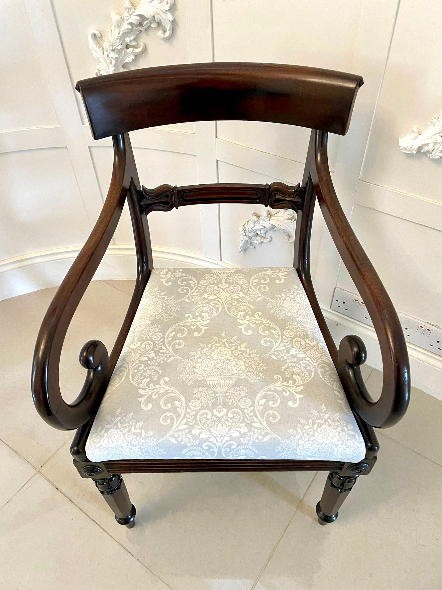 Antique Regency quality mahogany desk chair having a quality shaped mahogany top rail, carved mahogany shaped centre splat, scroll shaped open arms, newly reupholstered drop in seat in a quality fabric standing on shaped carved tapering legs to the