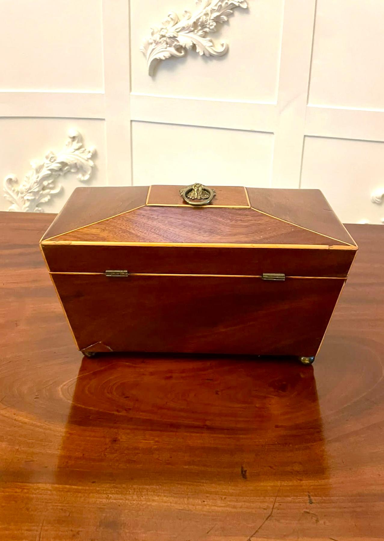 Antique Regency quality mahogany inlaid tea caddy having inlaid satinwood stringing, original ornate brass handles and escutcheon, lift up lid opening to reveal two tea caddies


Dimensions:
Height 16 cm 
Width 28.5 cm 
Depth 14 cm 


Dated 1825  
