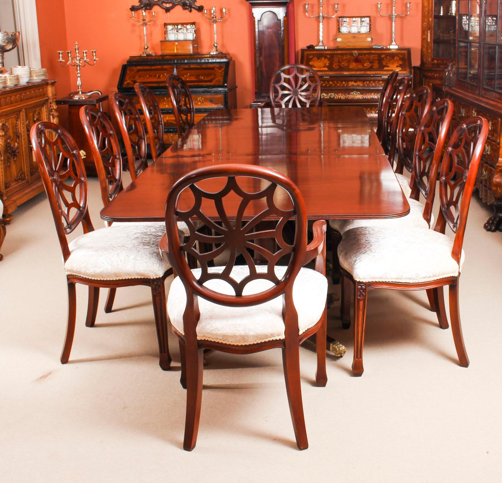 This is a fantastic high quality dining set comprising an antique flame mahogany Regency Revival triple pillar dining table circa 1900 in date and a bespoke set of twelve Spyder back dining chairs

The table is raised on three gunbarrel bases, each