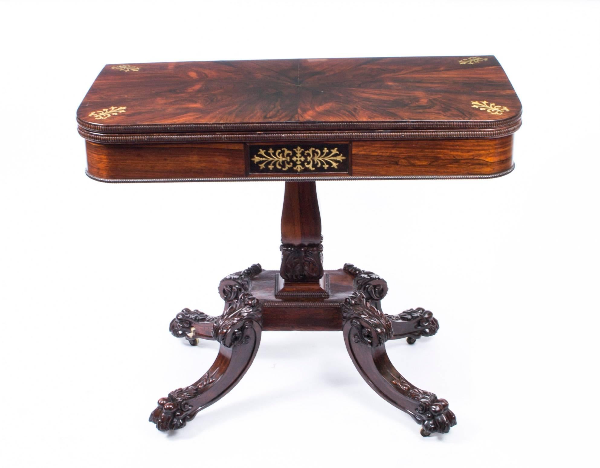 This is a very attractive antique English Regency rosewood and cut brass marquetry card table, circa 1825 in date.

This rounded rectangular card table is made from beautiful rosewood, the folding top enclosing a green baize lined playing surface.