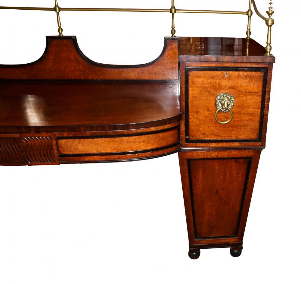 - Important antique Regency sideboard in satinwood and mahogany
- Love the black ebonized trim which accenuates the clean and minimal design
- Highly important fitted with original brass gallery
- Lions head ormolu handles original also
-