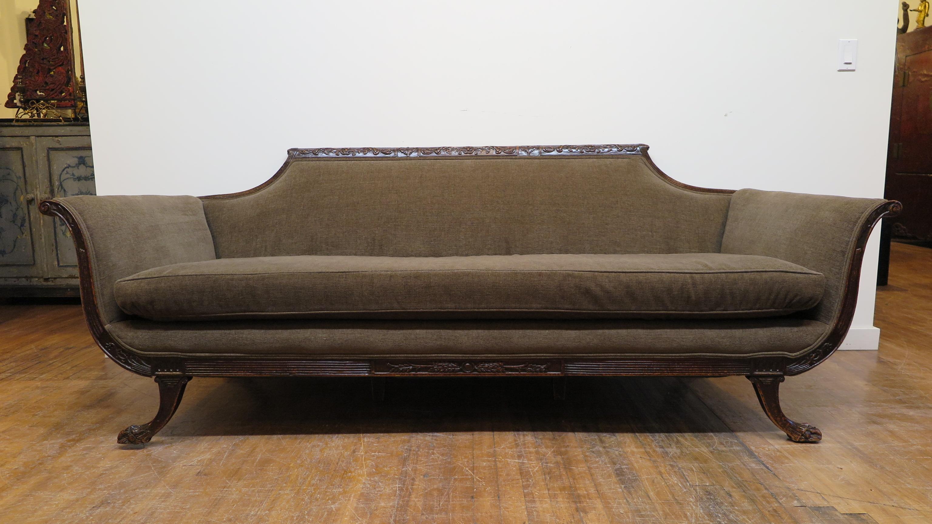 Antiquate Regency style scroll arm sofa. Hand carved mahogany in good condition. Please see photos. The wood and carving exhibit signs of wear, nicks and lose of color in keeping with a sofa of this age. Fabric is in very good condition, clean, no