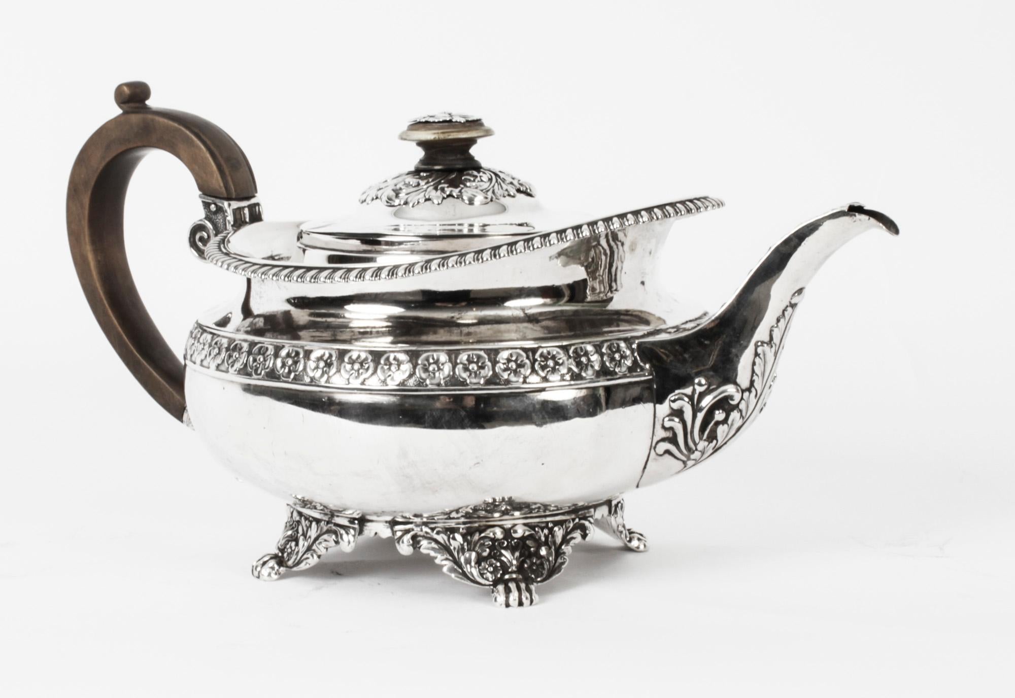 This is a wonderful antique George III sterling silver teapot with the makers mark of one of the most celebrated silversmiths, Craddock & Reid and dated 1820.
 
It features a squat, globular form with gadroon borders, floral accents, a C-form