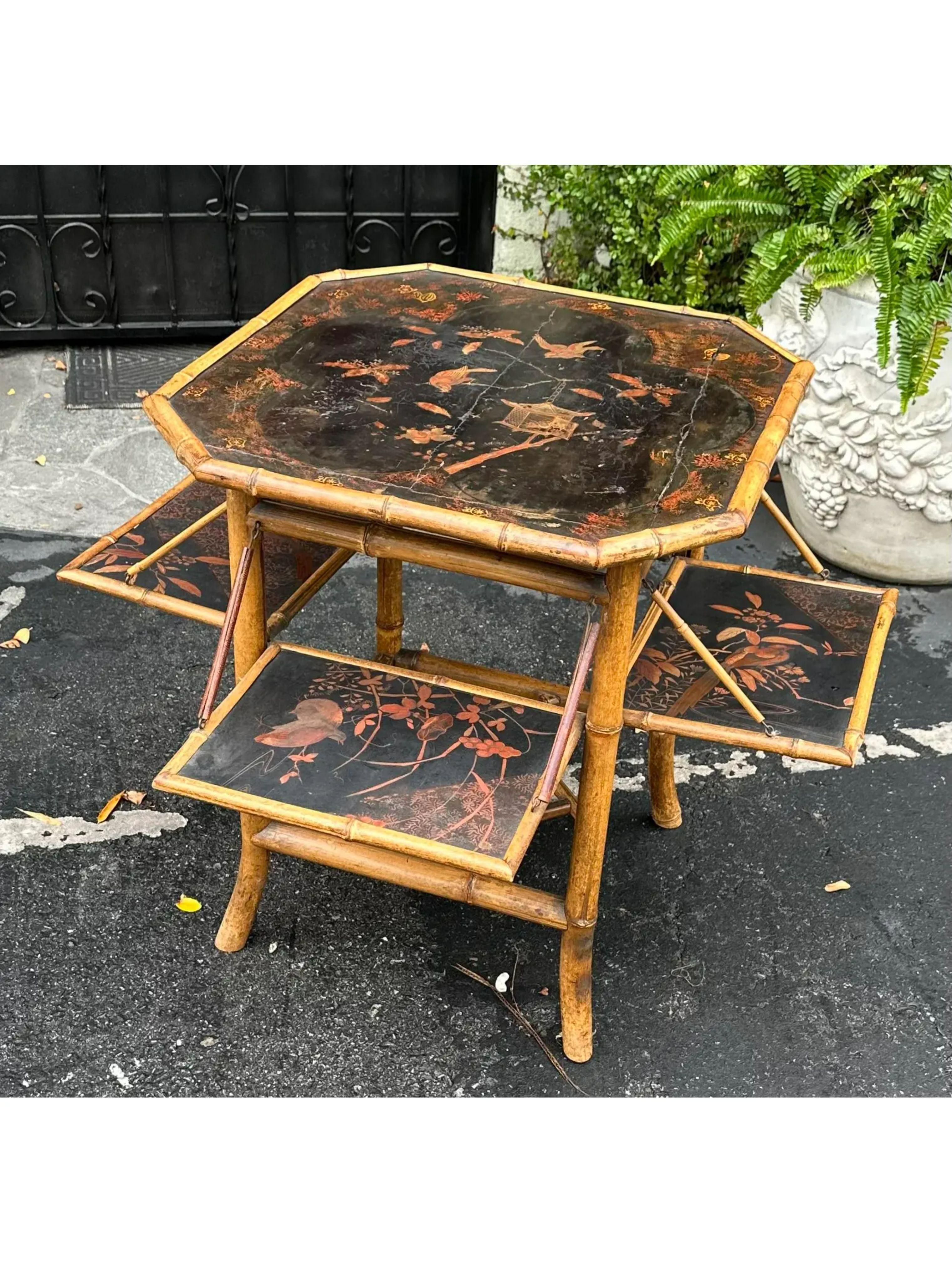 Antique Regency style black chinoiserie bamboo mulit drop leaf table. It features hand painted chinoiserie decoration with four folding drop leaves. The fully extended width is 36