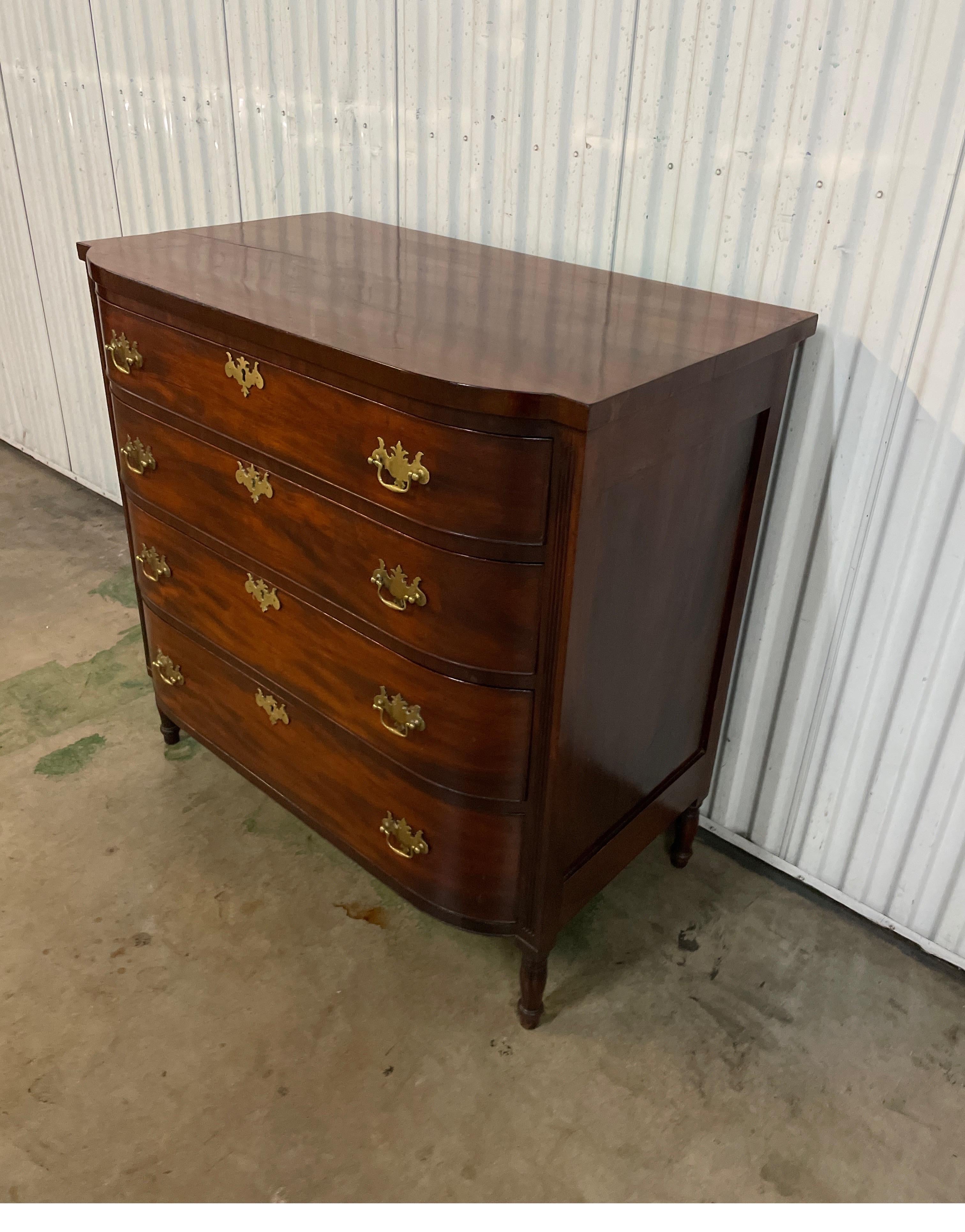 19th Century Regency Style four drawer bow front dresser with brass pulls & keyholes.