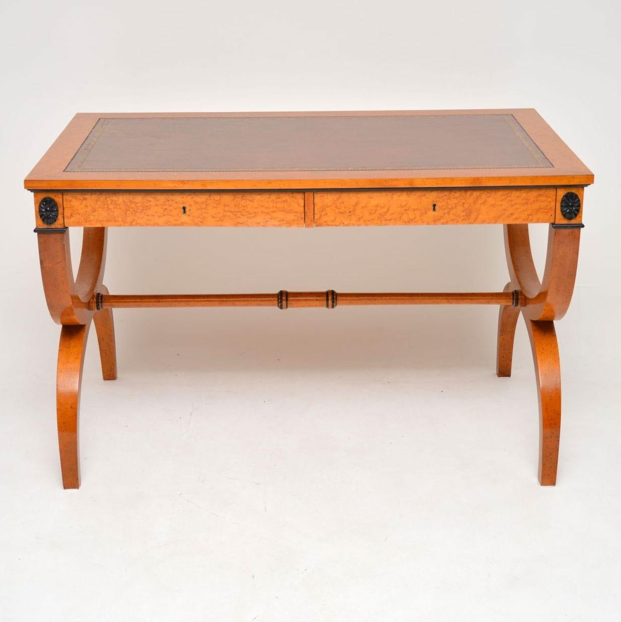 Very stylish antique Regency style writing table in perfect condition and dating from circa 1950s-1960s period. It’s bird's-eye maple with some ebony trimmings and is polished on both sides. The tooled leather writing surface is top quality hide.