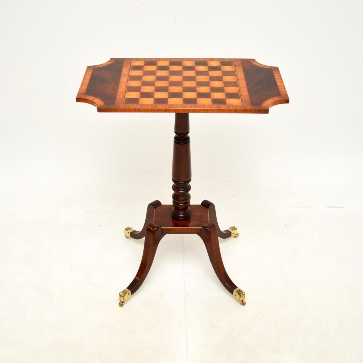 A stunning antique Regency style chess table. This was made in England, it dates from around the 1950’s.

It is beautifully designed and is of very high quality. The frame is inlaid with a walnut and satinwood chessboard, and has a cross banded edge