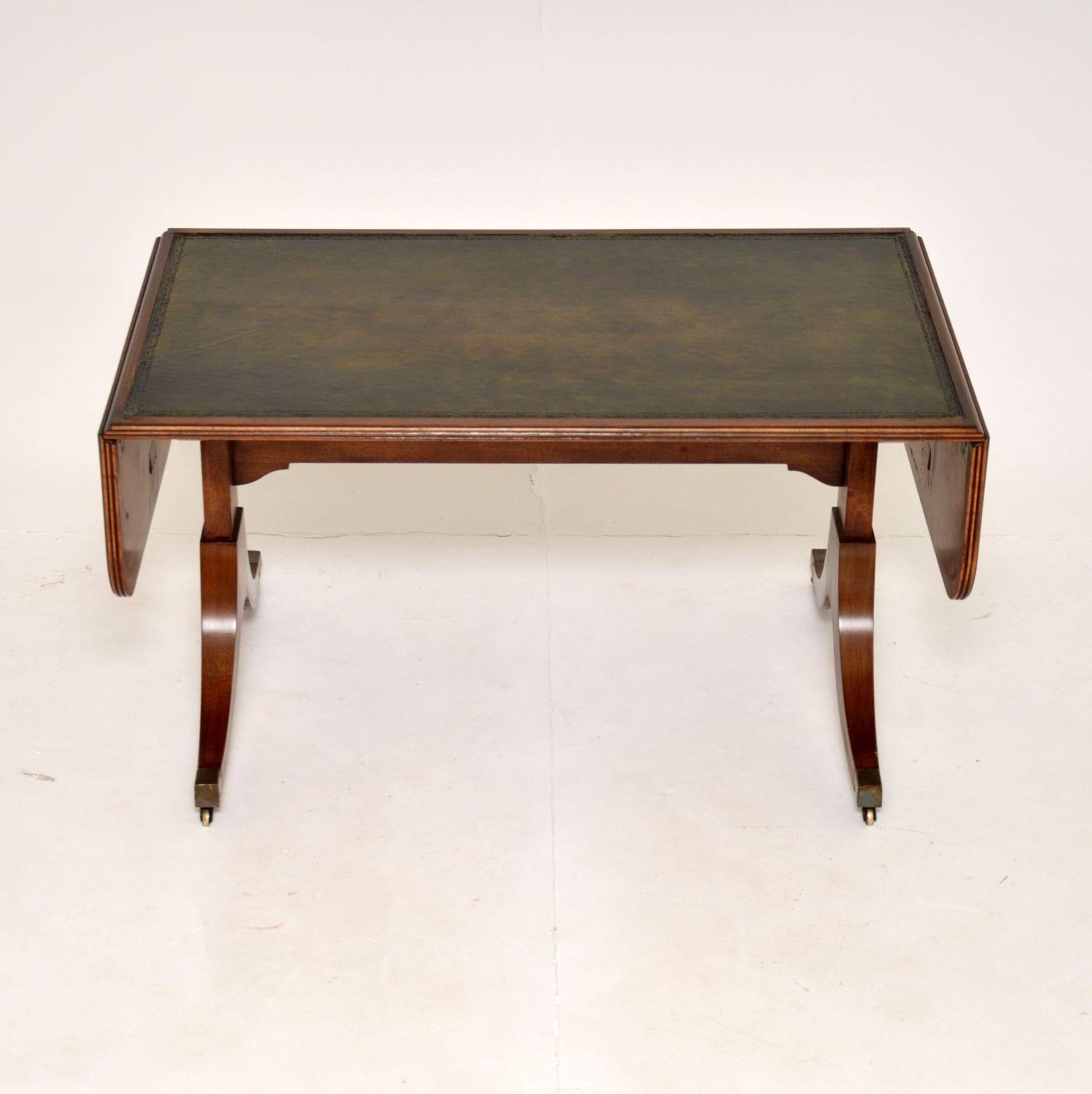 A lovely antique Regency style drop leaf coffee table. This was made in England, it dates from around the 1930’s.

It has a stylish and useful design, the drop down ends lift up and are supported with pull out rails to increase the surface area