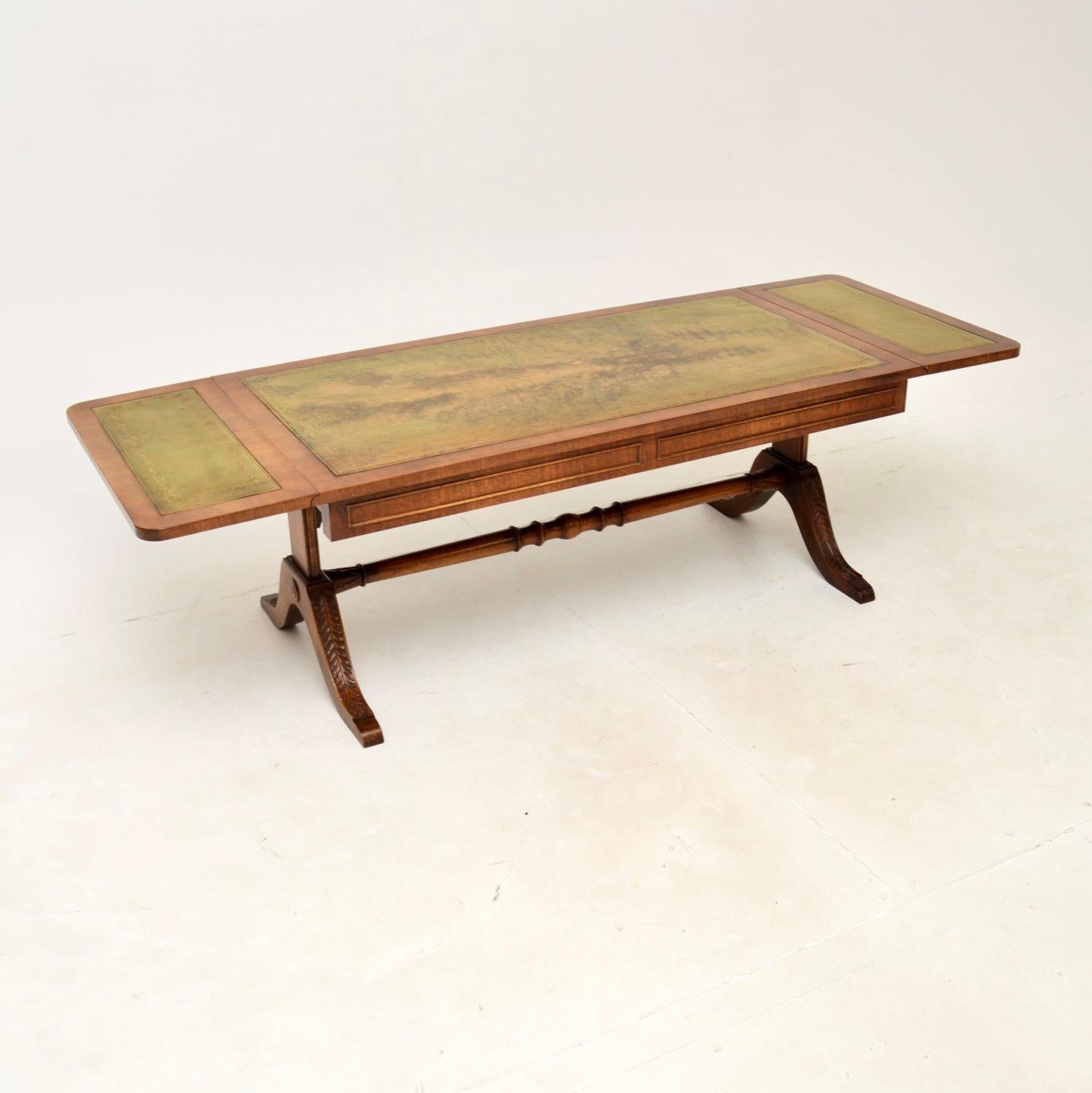A wonderful antique drop leaf coffee table, made in England and dating from around the 1930-50’s.

This is of superb quality and has a very useful design. It sits on a stretchered base with carved feet, the top has beautiful inset tooled leather.
