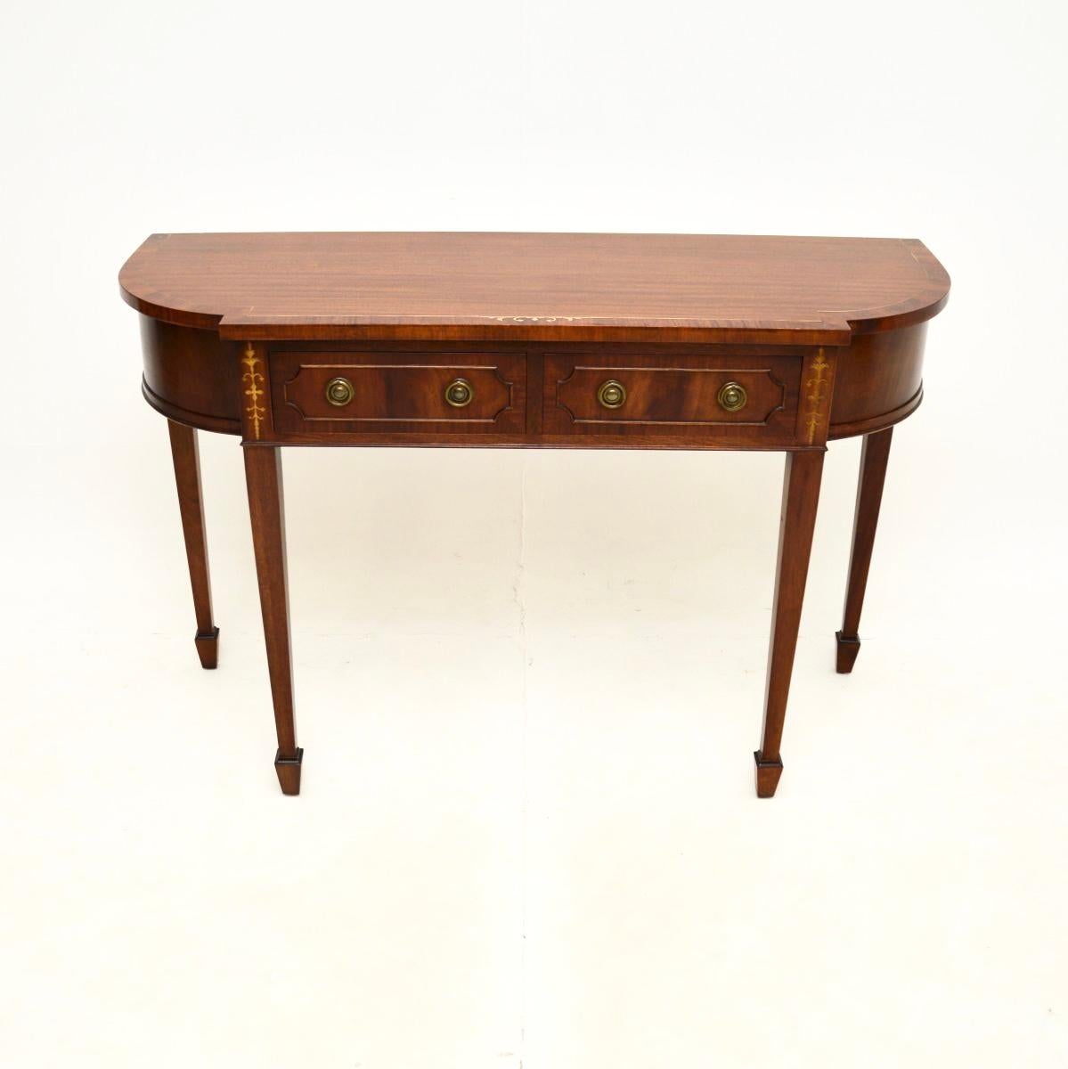 An impressive antique inlaid brass console table. It is in the Regency style, it was made in England and dates from around the 1950’s.

This is of outstanding quality, the wood has gorgeous grain patterns and the brass inlays compliment it