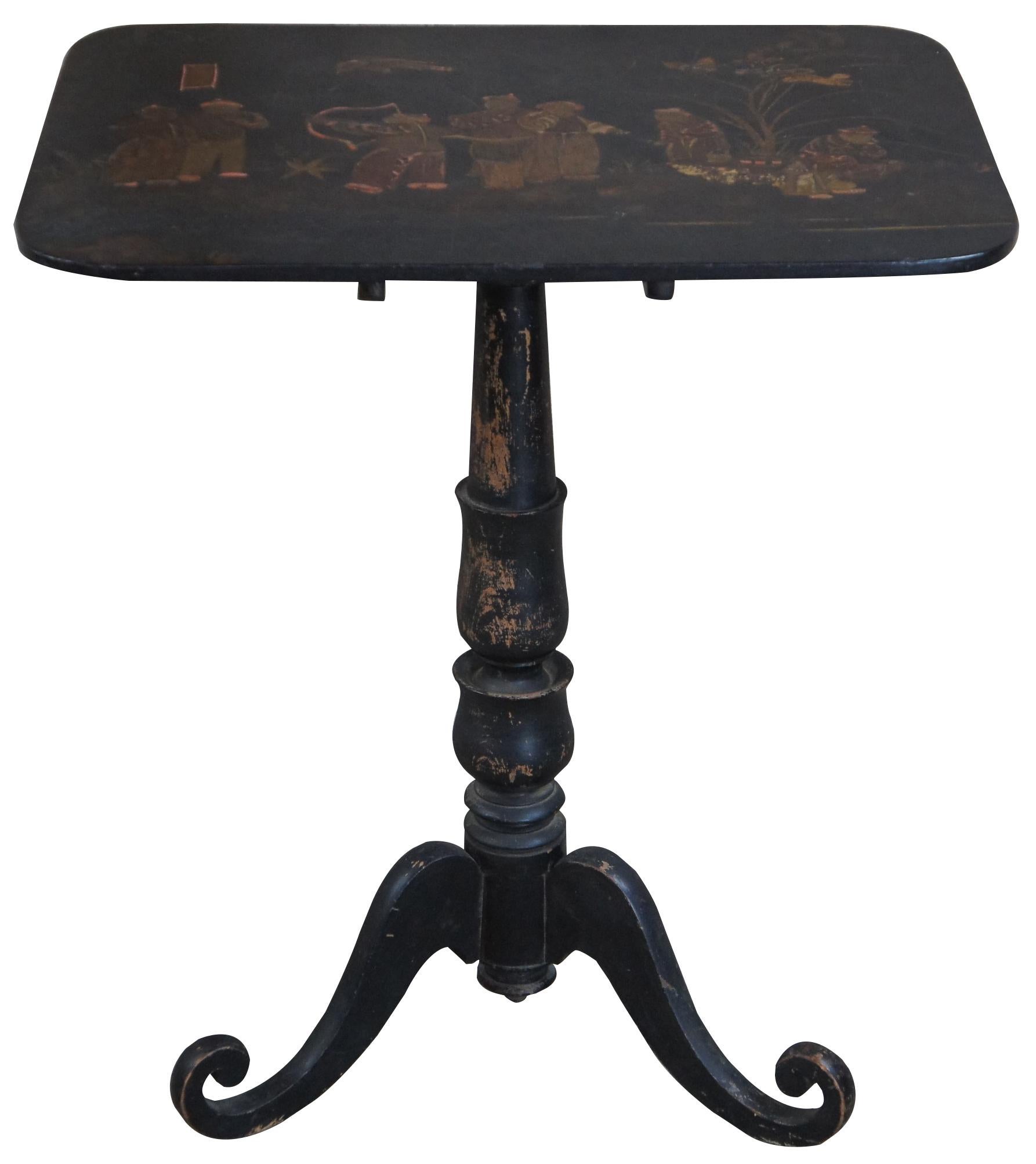 Antique Regency jappanned tilt top table. Features a distressed back finish with figures along the table top. Depicts a carnival scene with musicians, smokers and bow and arrow. Measure: 28