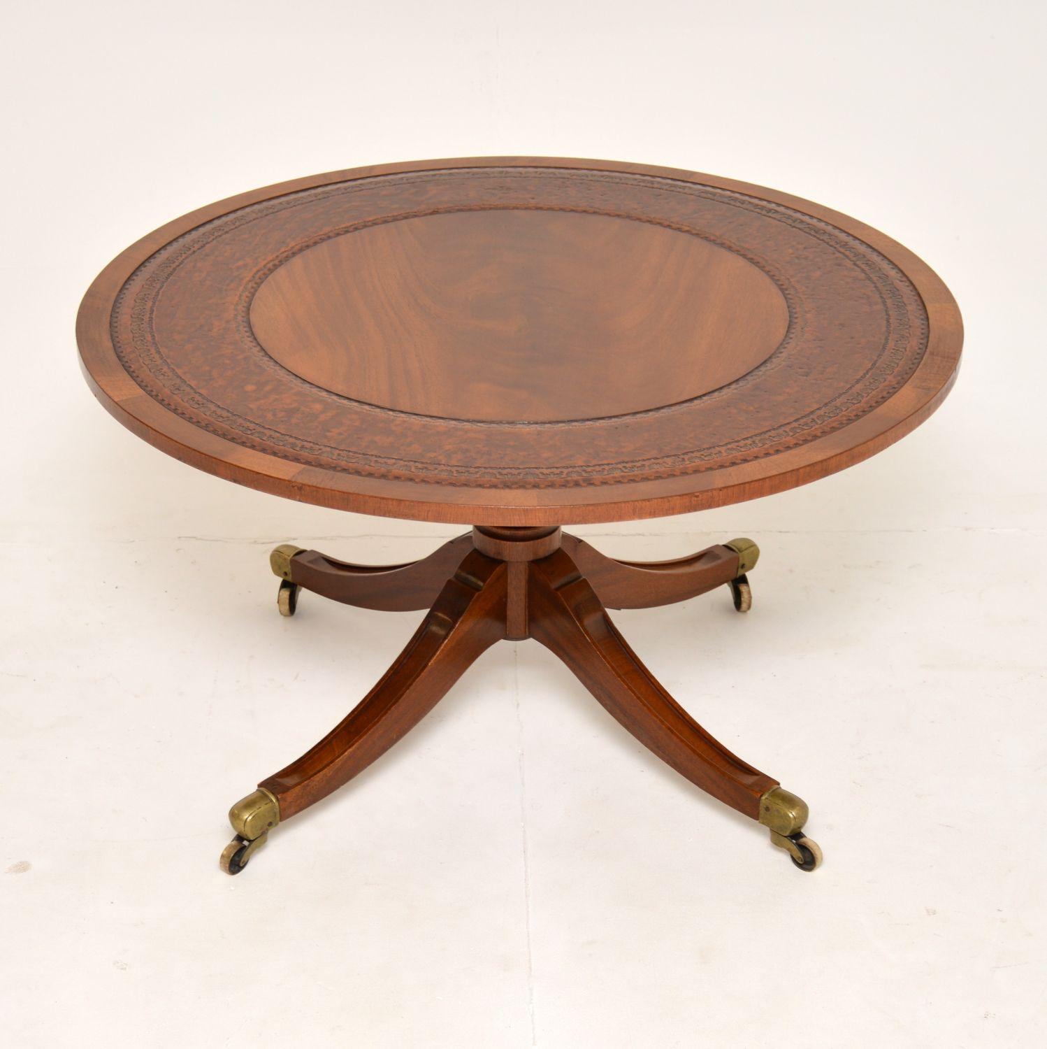 A wonderful antique circular coffee table in the Regency style. This was made in England & dates from around the 1930’s.

The quality is amazing, this is extremely well made and is a great size. The circular top has a flame wood centre and edges,