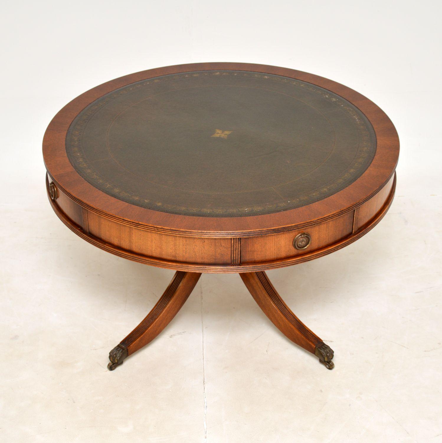 A large and impressive antique coffee table in the Regency style. This was made in England, it dates from around the 1930’s.

This is of superb quality, it is a great size and has four useful drawers built into the circular drum shaped top. The