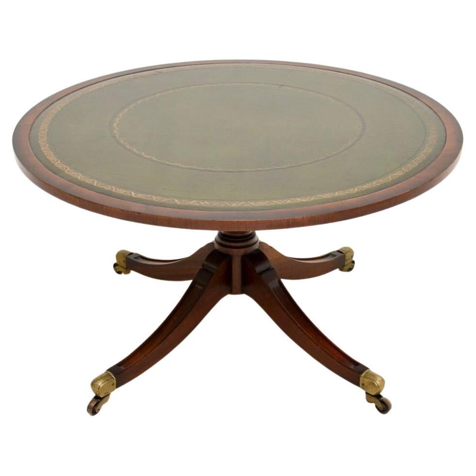 A smart and useful antique Regency style leather top coffee table. This was made in England, it dates from around the 1950’s.

The quality is superb, the large circular top has an inset green leather surface with tooled edges. It sits on a solid