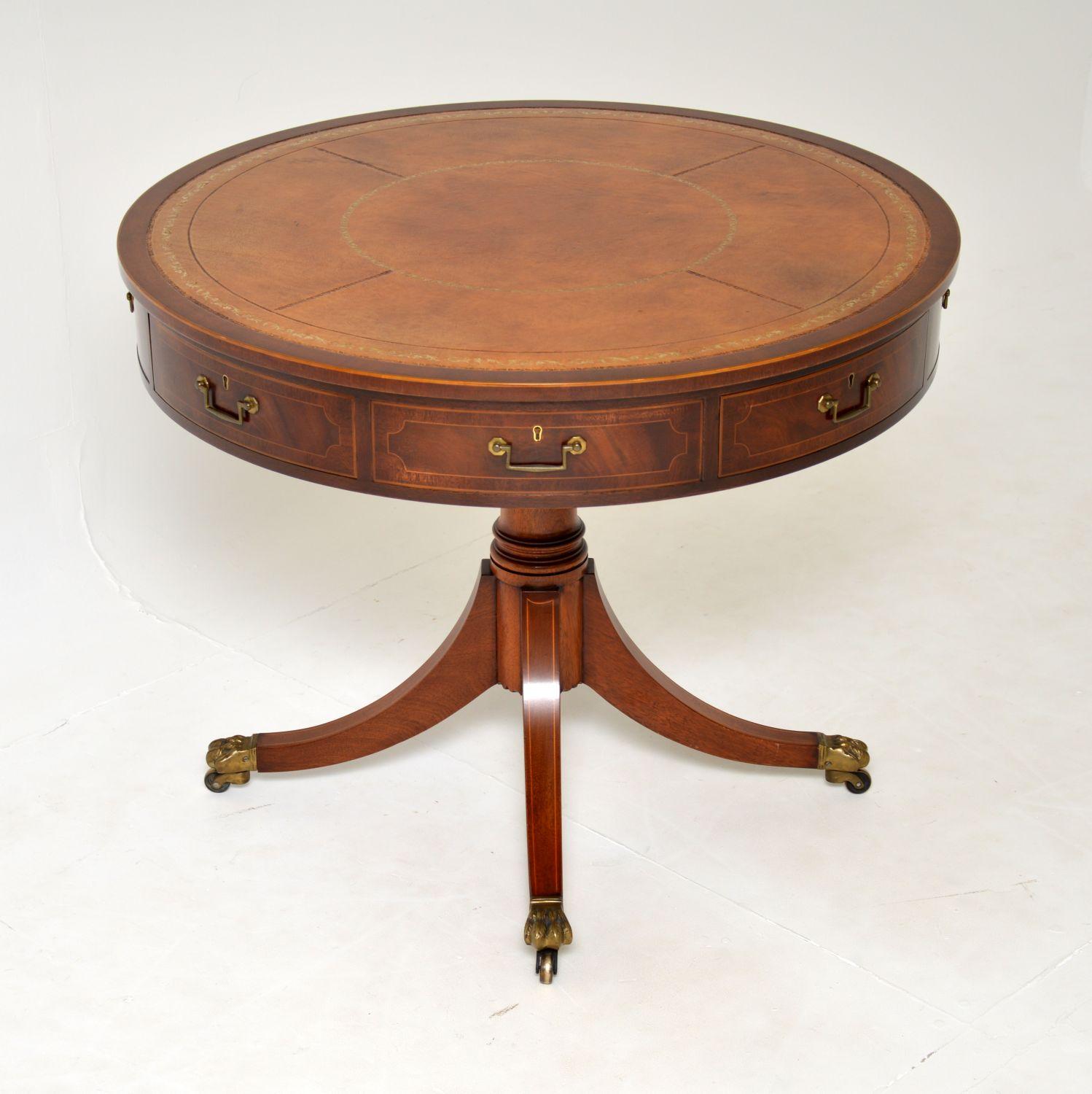 A superb antique Regency style leather top drum table with satinwood inlays, dating from around the 1950’s period.

The quality is superb, this is really well made and has a gorgeous design. There is a beautiful hand coloured gold tooled segmented