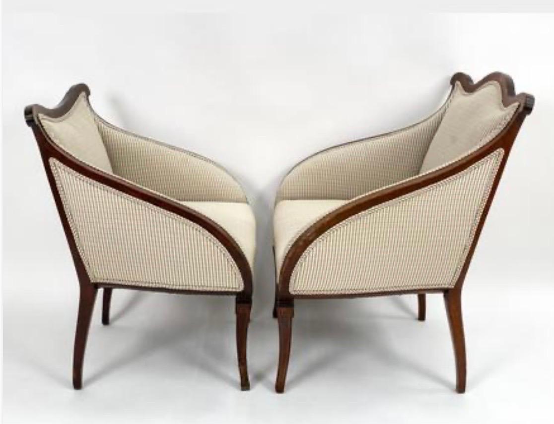 Magnificent set of His & Hers antique regency chairs with gorgeous mahogany inlay. Each piece has sloping arms and ornate inlay at base and seat. Upholstered in a luxurious cream and sage green fabric with double welting.
Larger chair measures 27.5