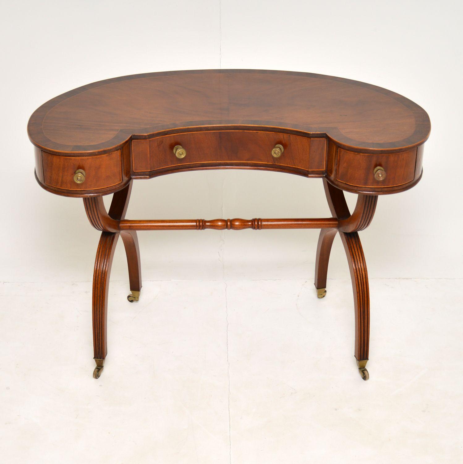 A gorgeous antique kidney table in the Regency style, this dates from around the 1910-20’s. It is a great size to be used as either a desk or a dressing table.

This has a beautiful design and is of wonderful quality. The shape and design is