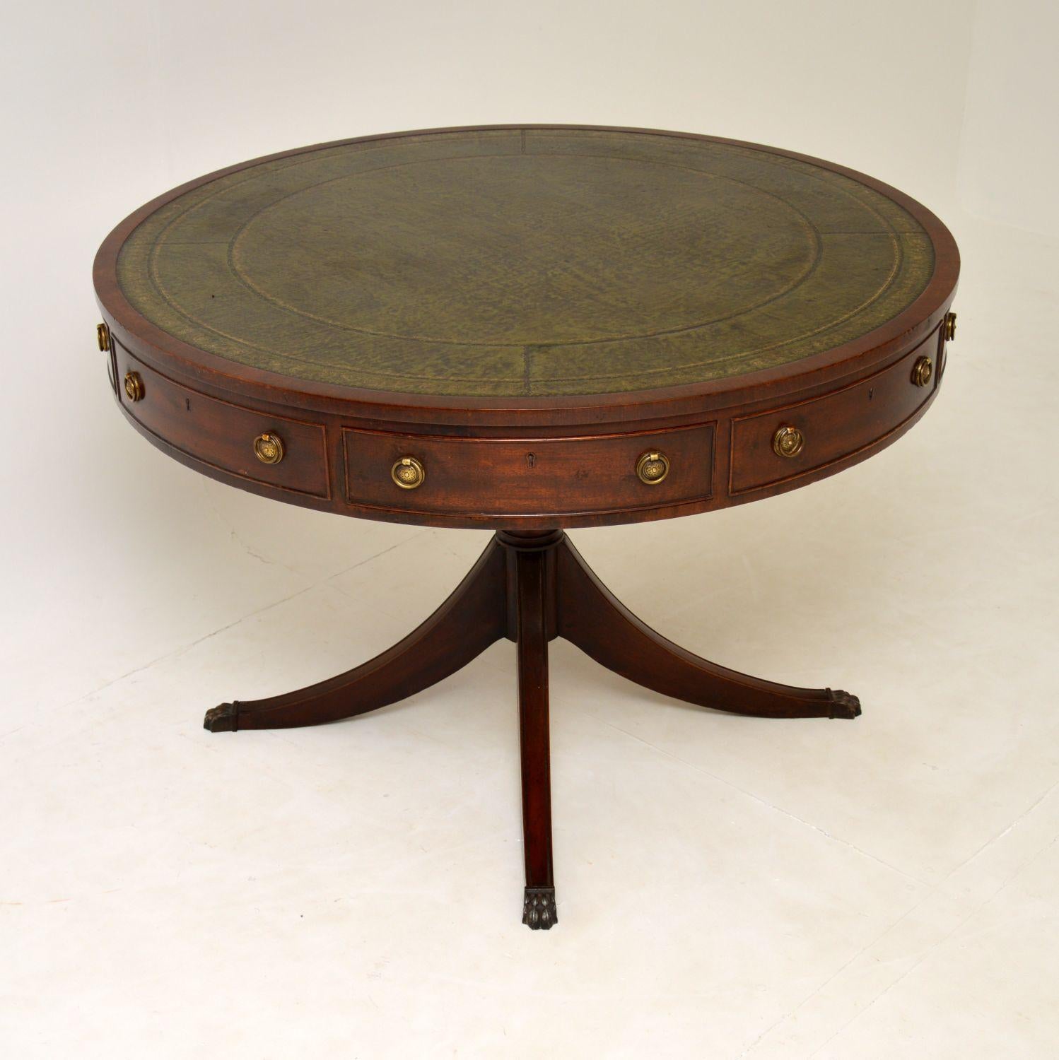 A large and impressive mahogany drum table, with an inset leather top. This is in the antique Regency style, it dates from around the 1950’s.

The quality is excellent, it is very well built, and the top rotates. There are four drawers and four