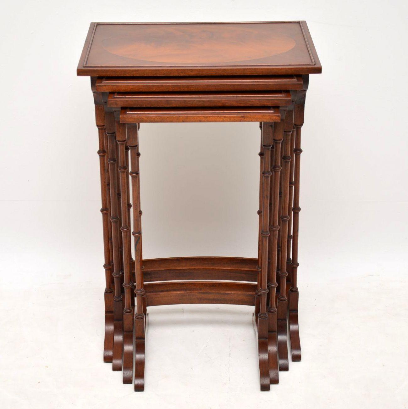 Antique Regency style mahogany nest of four tables of very high quality and in excellent condition, having just been French polished and dating from circa 1920s period. Each tabletop has an oval flame mahogany panel inset in the middle, with an
