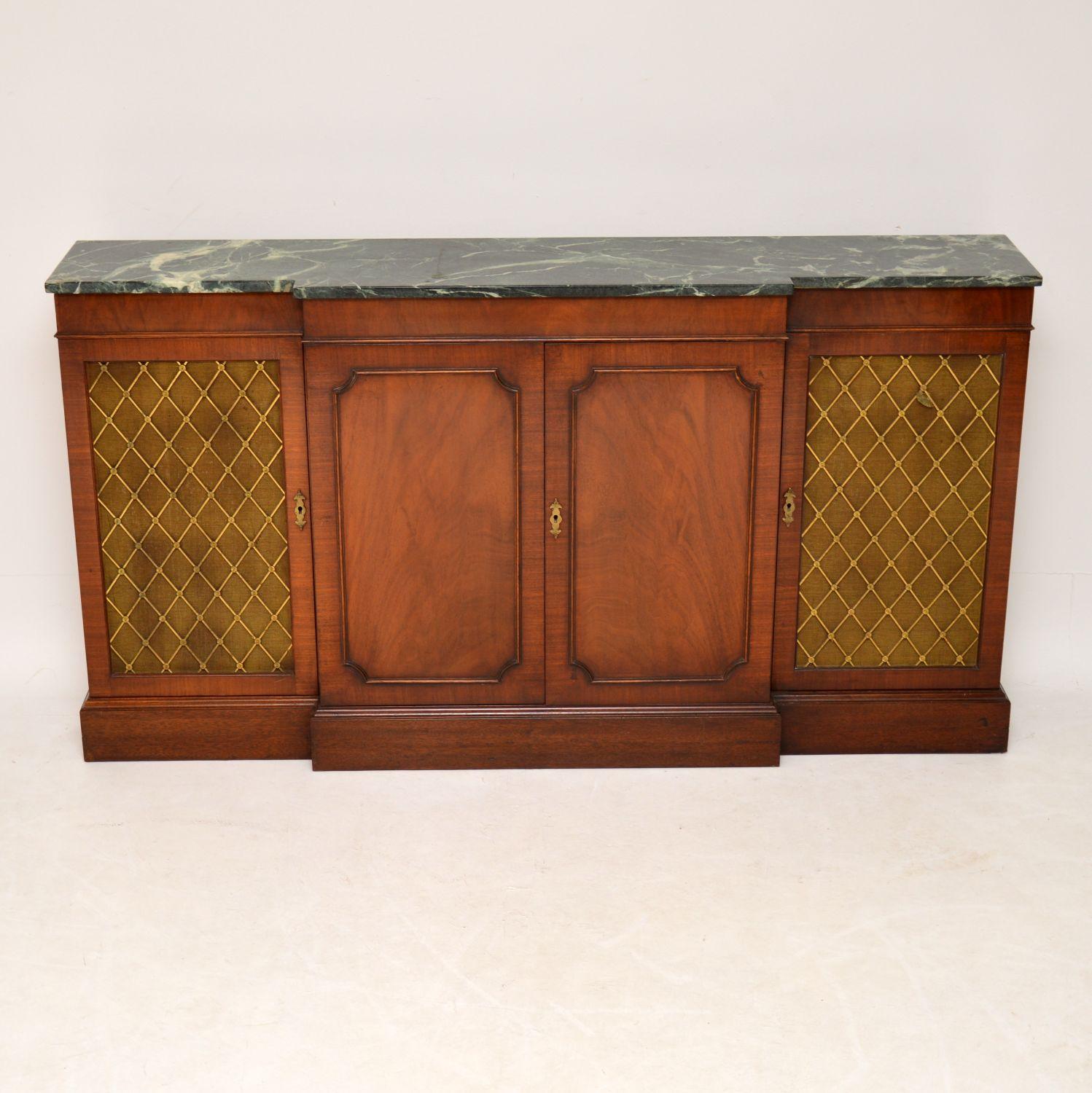 Very practicable sideboard which is long and slim from back to front and with lots of storage inside. It’s antique Regency style, dating roughly from the 1950s period and in good original condition, having just been French polished. The marble top