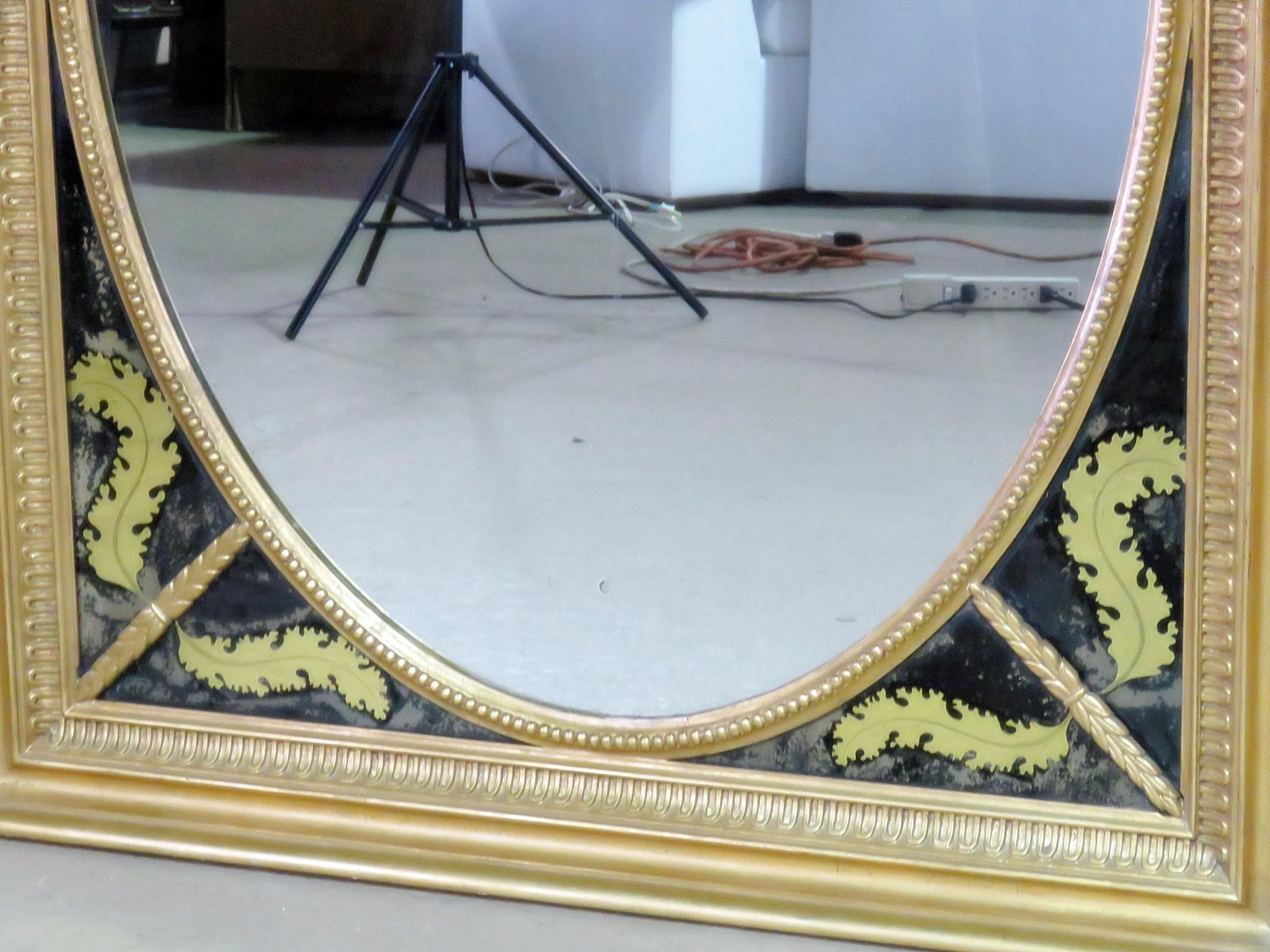 Miroir antique de style Régence avec cadre doré et verre peint inversé.