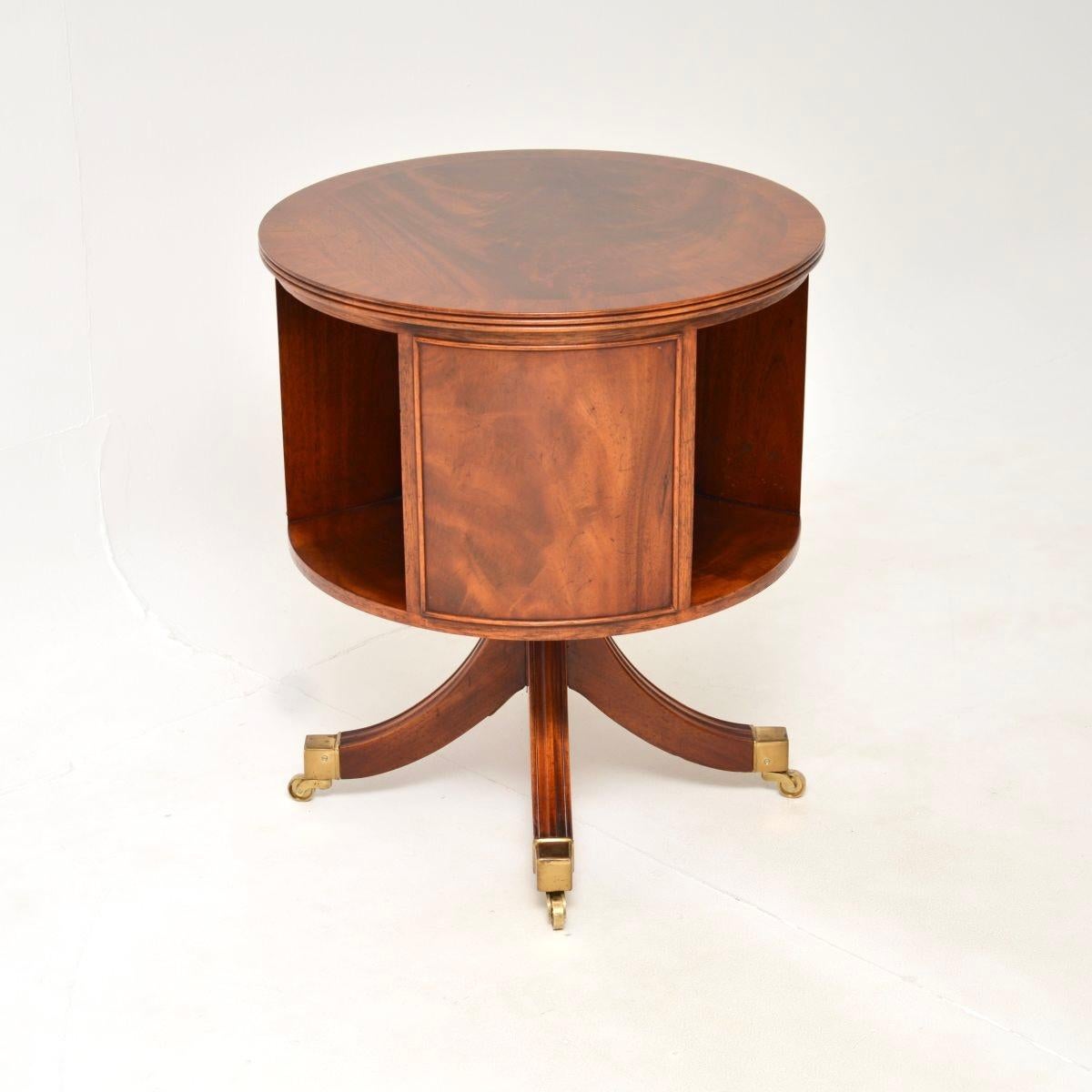 A wonderful antique Regency style revolving drum table. This was made in England, it dates from around the 1950’s.

The quality is outstanding, this has a wonderful cylindrical top with panelled sides and open recesses for books. The top surface has