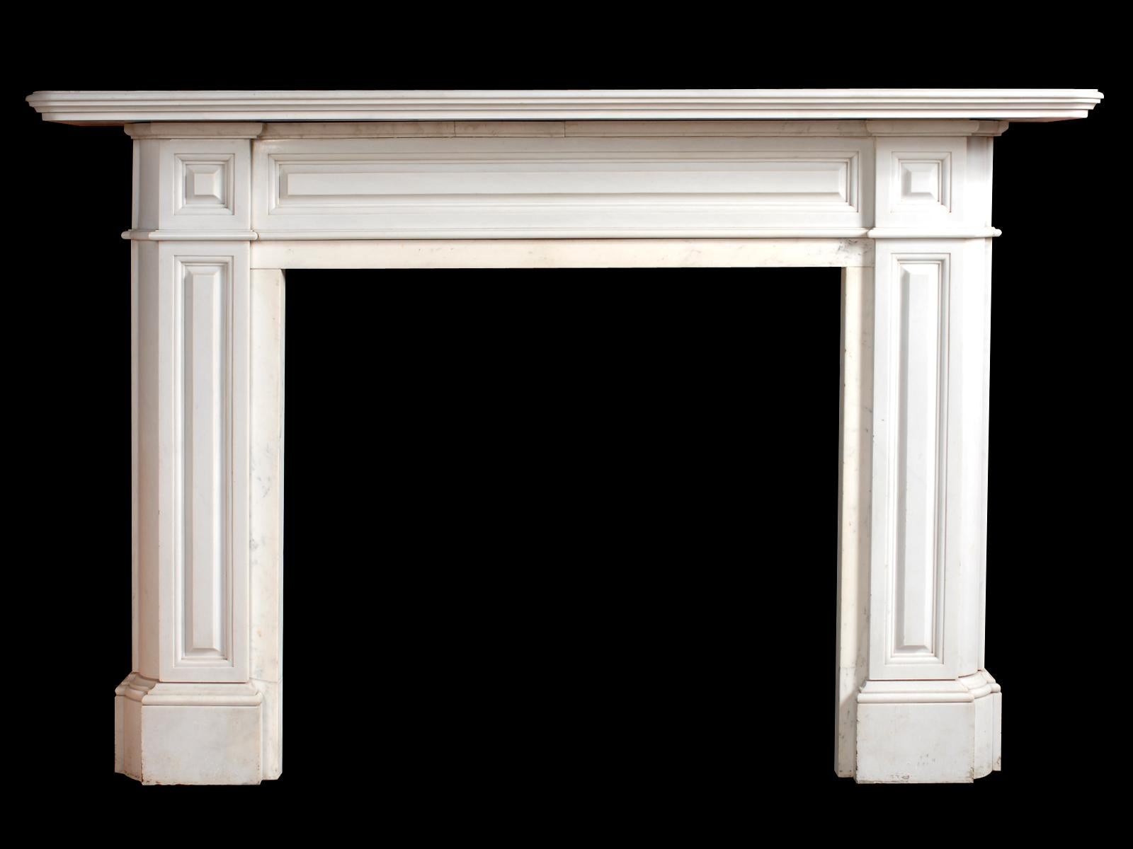 A very large and substantial, Italian statuary white marble fireplace in the Regency manner. Having a generous stepped and moulded mantel. The frieze, jambs and end blocks with conforming raised fielded panels, mid-19th century.