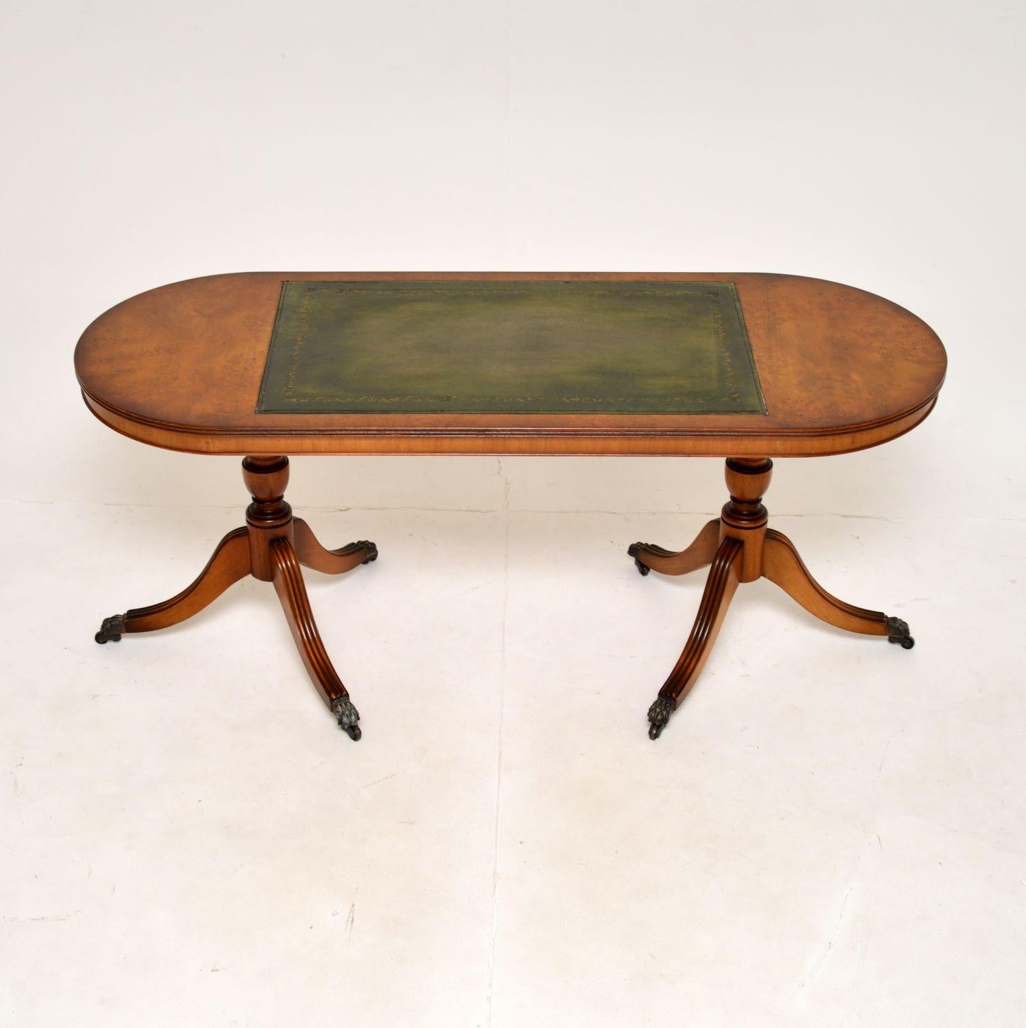 A beautiful and very well made antique Regency style walnut and leather coffee table. This was made in England, it dates from around the 1930’s.

This is of superb quality and is a very useful size. The oval shaped top has stunning burr walnut grain