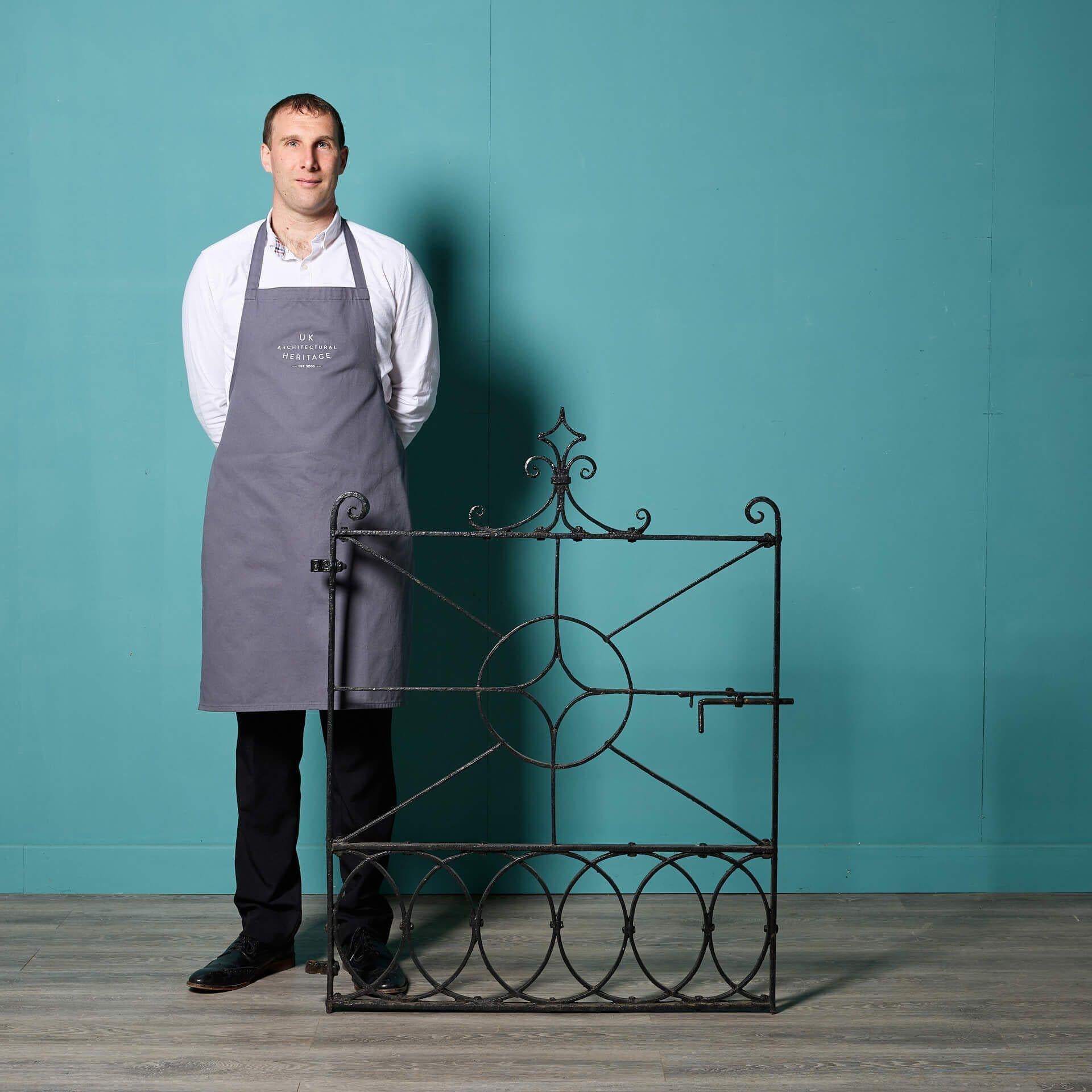An antique Regency style wrought iron side gate with unusual design, circa 1800. Over 220 years old, the fine craftsmanship of this antique garden gate has stood the test of time, making a smart addition to any outdoor setting seeking a flourish of