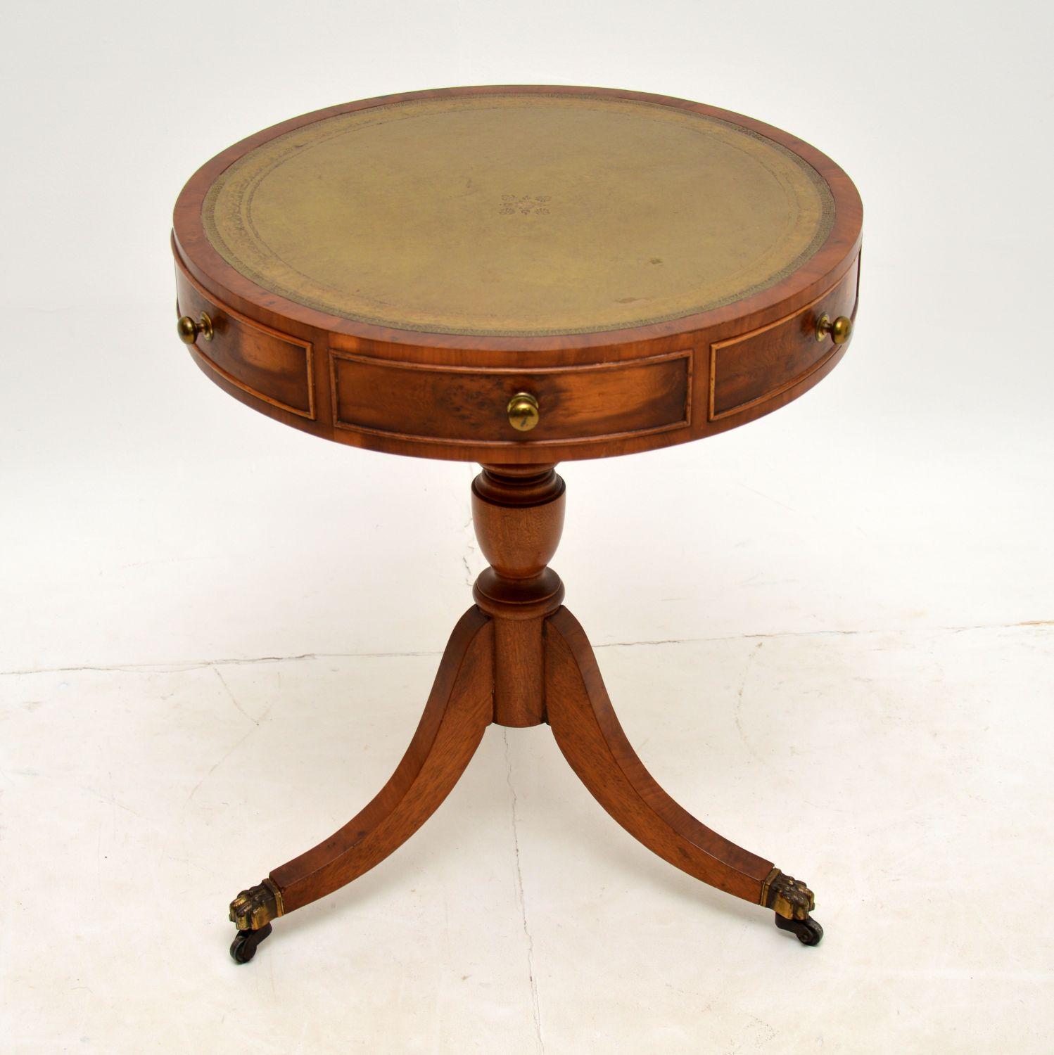A beautiful yew wood, leather top drum table with a spinning top, in the antique Regency style. This was made in England & dates from around the 1930’s.

It is of lovely quality and has very useful proportions. The inset leather top has a lovely