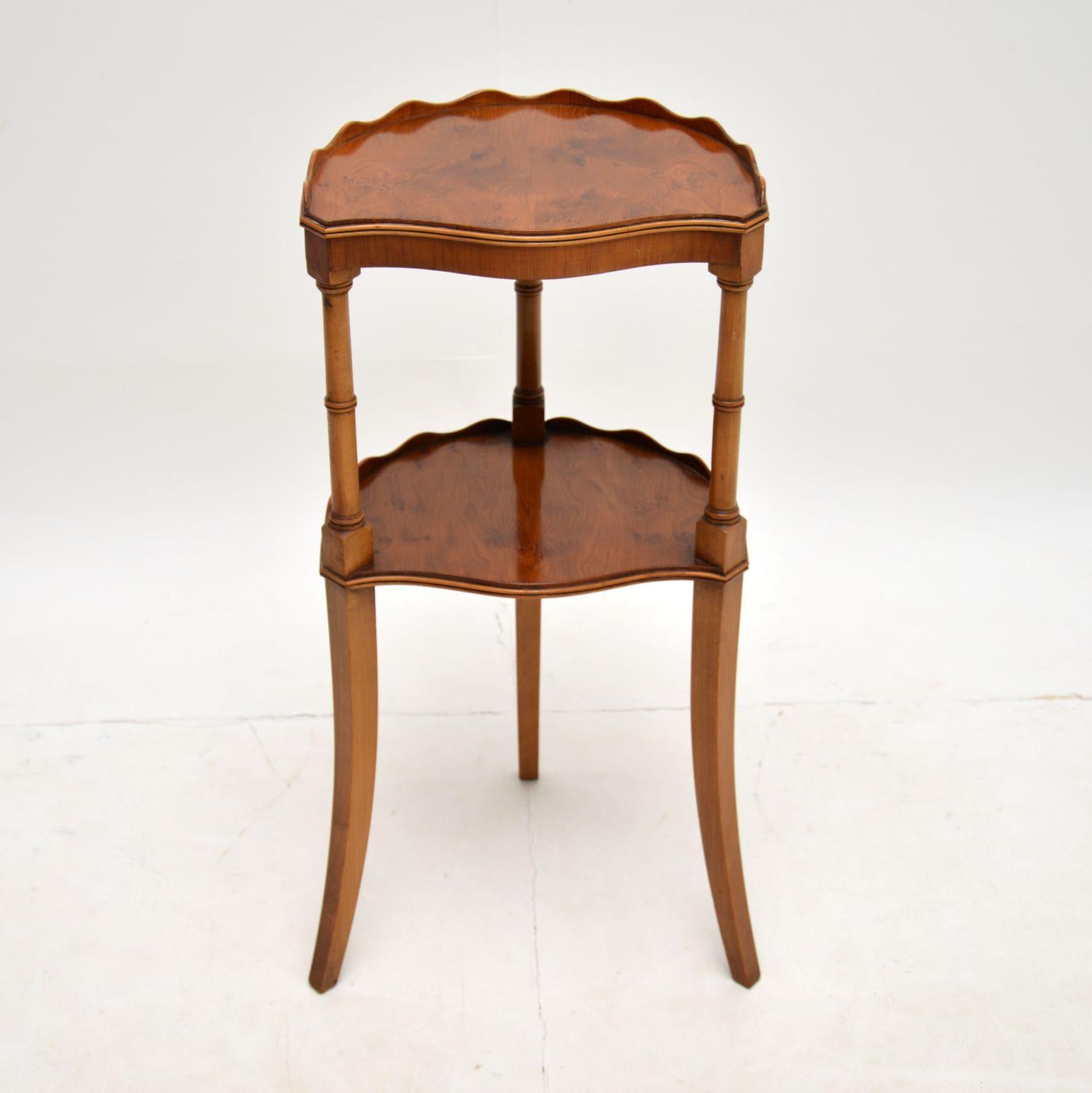 A charming yew wood two tier side table in the antique Sheraton style. This was made in England, it dates from around the 1950’s.

Beautifully made and with a very elegant design, this is a very useful size. it is nicely finished on all sides, so