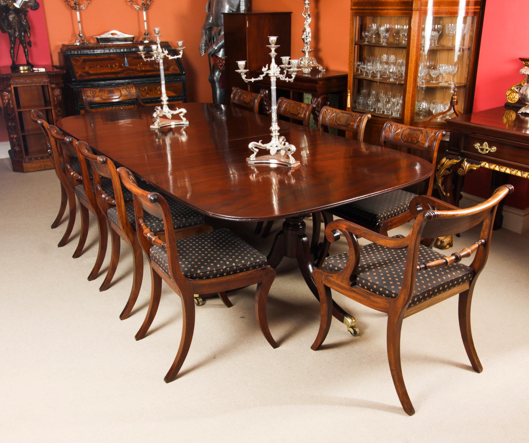 This is an elegant dining set comprising an antique Regency Period dining table with a set of ten Regency Period dining chairs, all dating from Circa 1820.

The table is of rectangular form with rounded corners and reeded edge. It is raised on twin