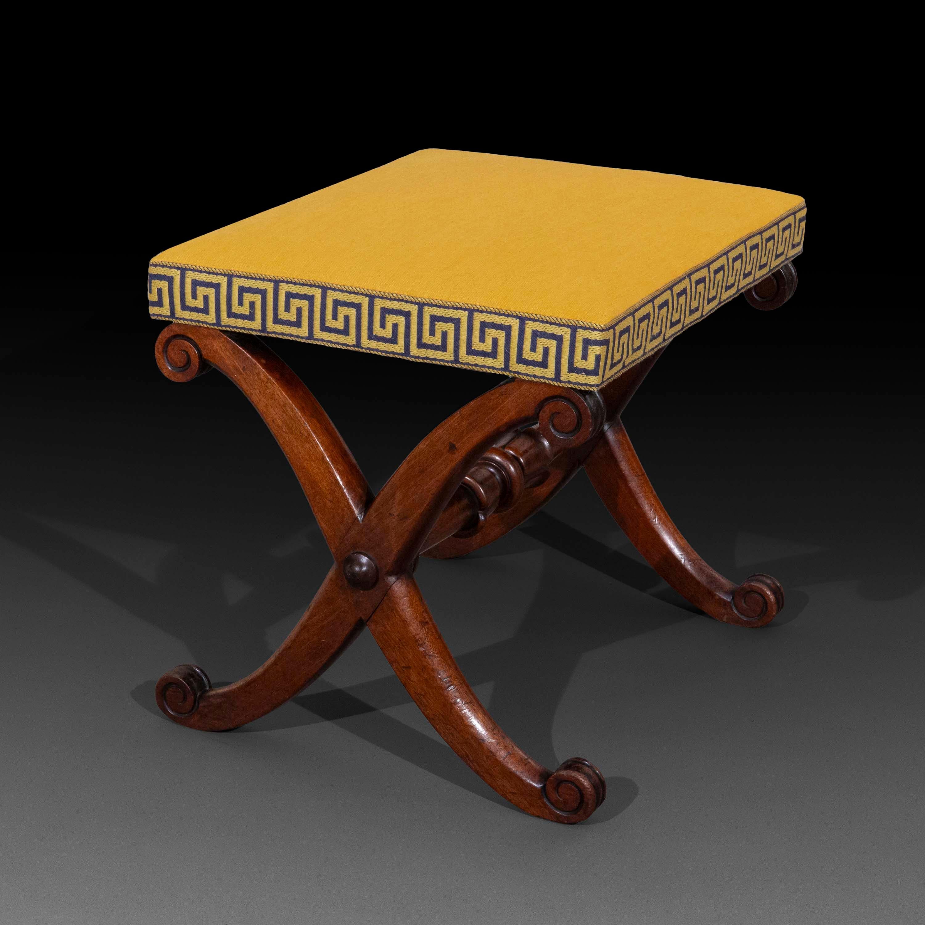 A rare example of a finely drawn Regency period x-frame stool or bench, beautifully upholstered in butter yellow cotton with wide Greek key meander trim. Of Gillows style and quality, after a design by Thomas Hope.
English, circa 1810–20.

Why we