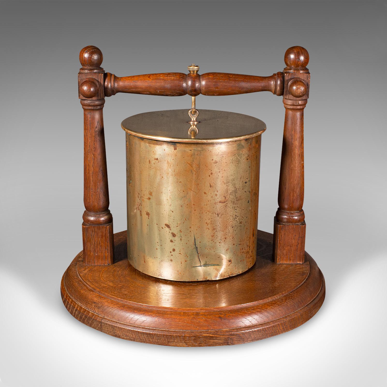 
This is an antique regimental gong. A German, brass ordnance shell upon an oak base, dating to the First World War, engraved 1916.

Fascinating repurposed ordnance, in the manner of Trench Art
Displays a desirable aged patina, the shell casing