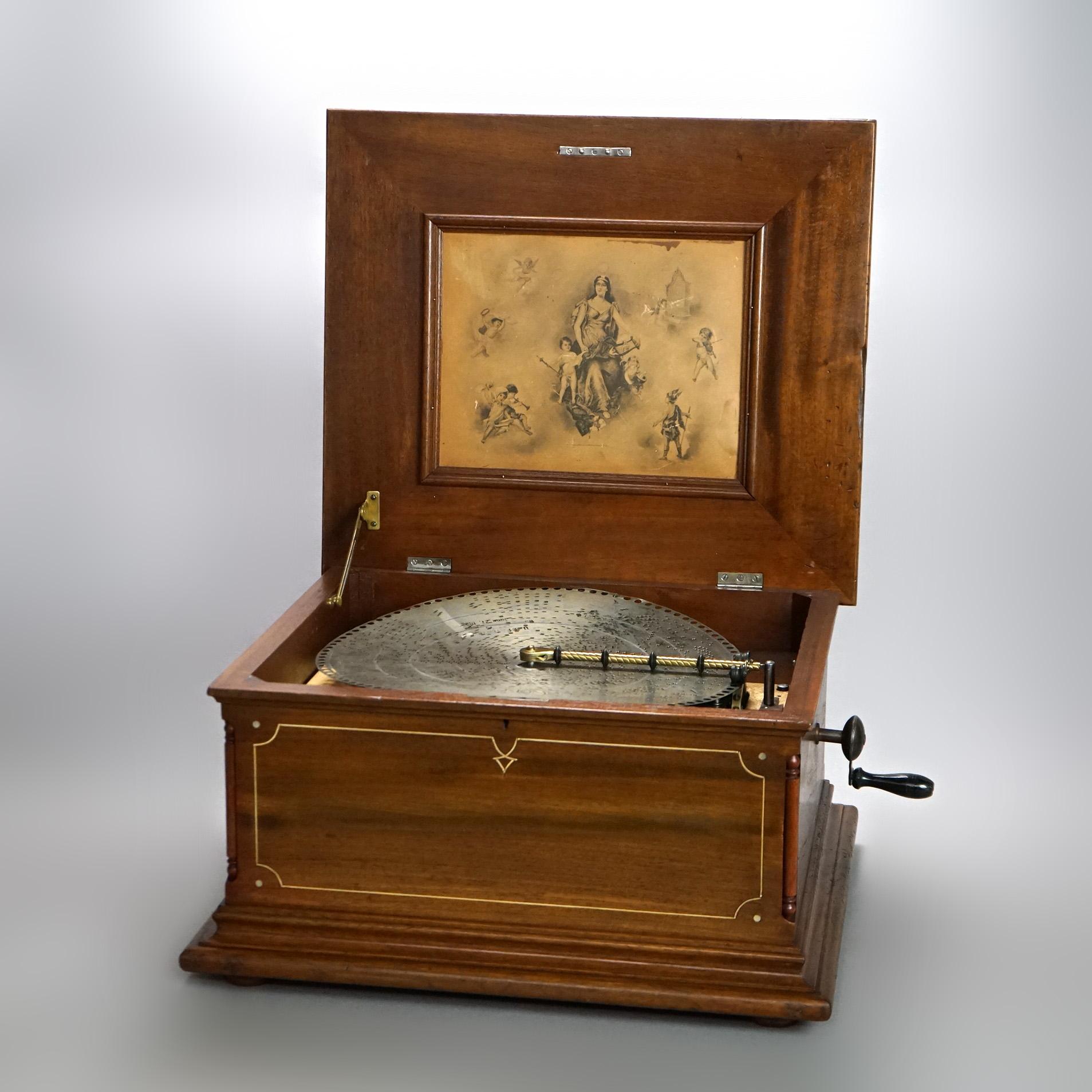 An antique Regina music box offers mahogany case with inlaid banding, serial #55116, includes five discs, 19th century

Measures - 13.25