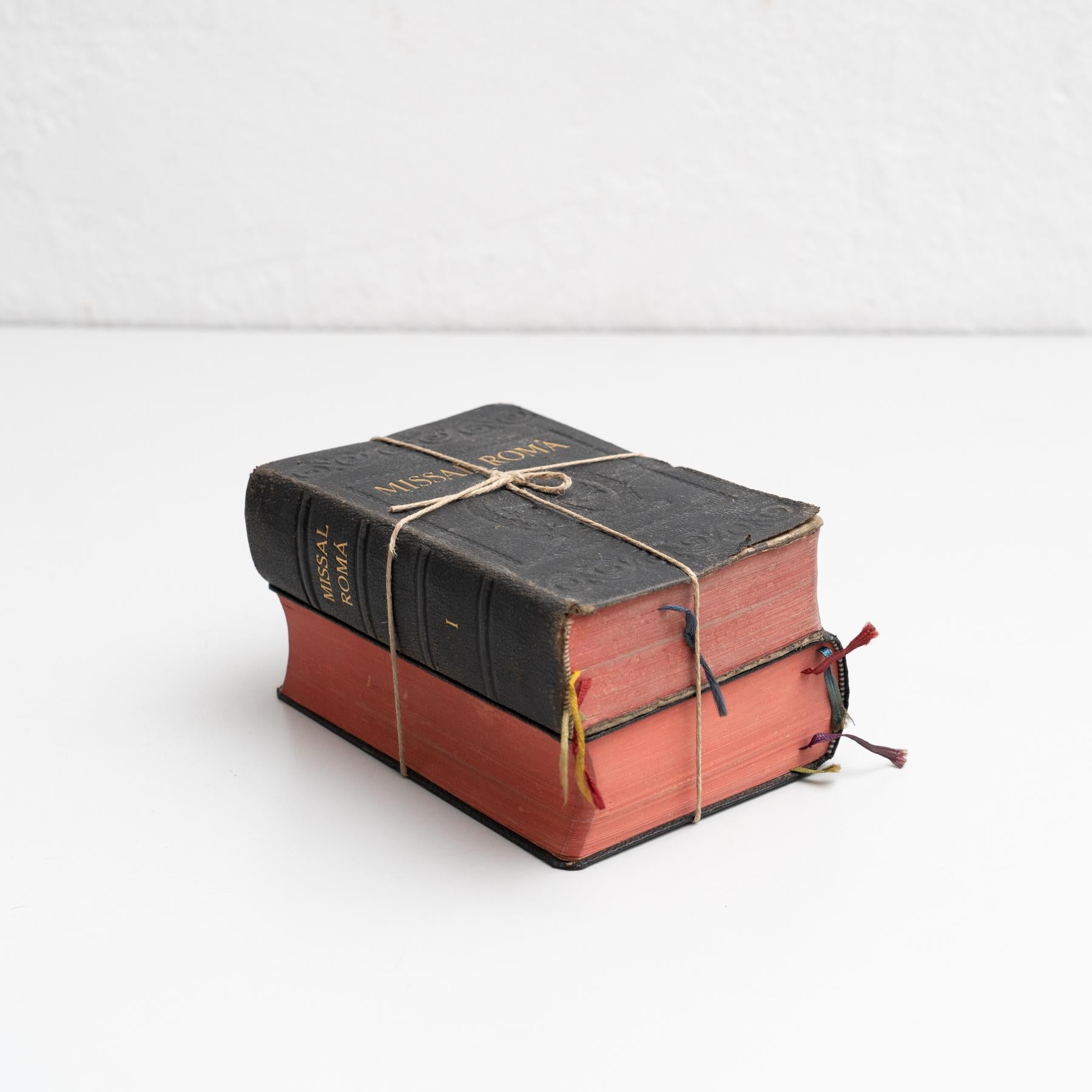 Antique religious book artwork consisting of two books tied together by a thread.

Two volumes of the Roman Missal published in Catalan by an Unknown editor.

In original condition, with minor wear consistent with age and use, preserving a