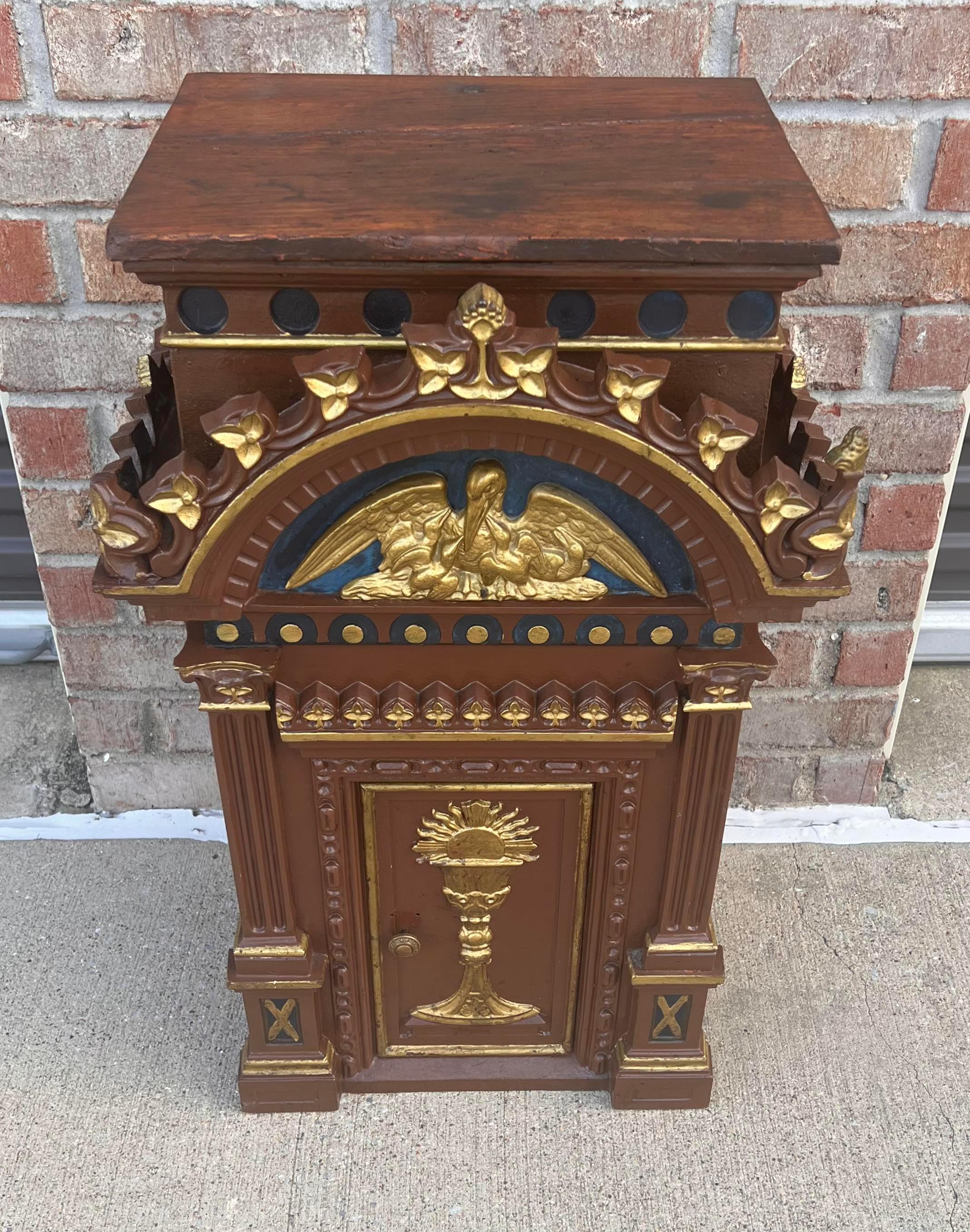 A scarce antique European religious polychromed gilt wood and cast iron mounted church altar tabernacle.

Hand-crafted in the 19th century, high-quality solid wood and cast iron construction, in polychrome painted finish, Empire style, sculptural