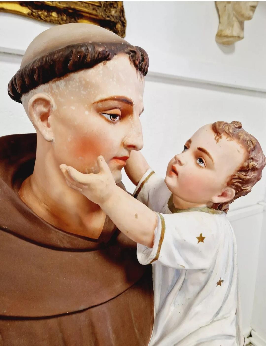 This life-sized sculpture from the early 20th century depicts Saint Anthony of Padua in fantastic realism. The piece is hand-carved from plaster with intricate details that capture the essence of the subject. The statue stands at an impressive 158cm