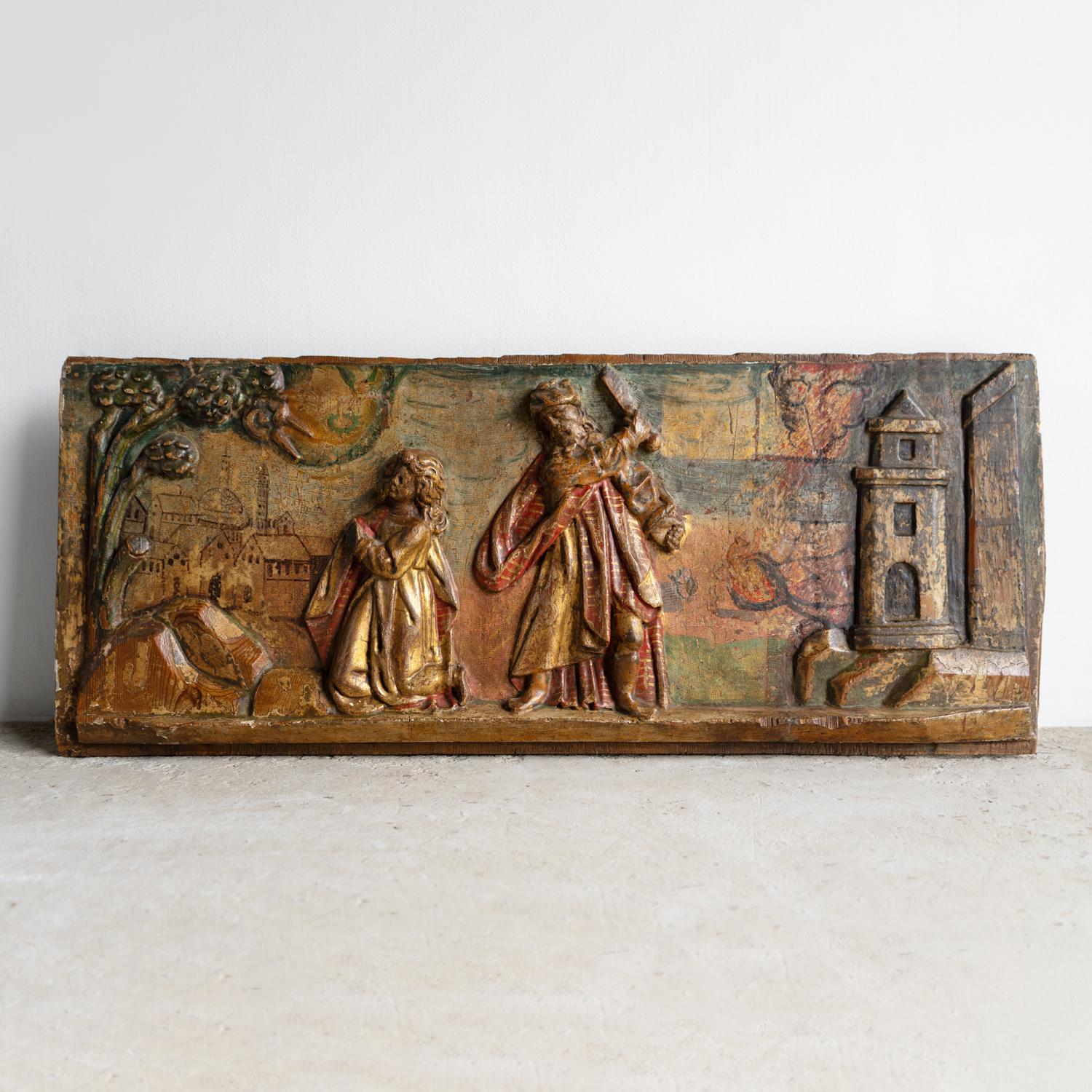 ANTIQUE CARVED PANEL 

Depicting a dramatic biblical scene, possibly related to the Old Testament story of Abraham and Issac. A younger figure is depicted on their knees praying, whilst the older figure has a bladed article raised, ready to swing.