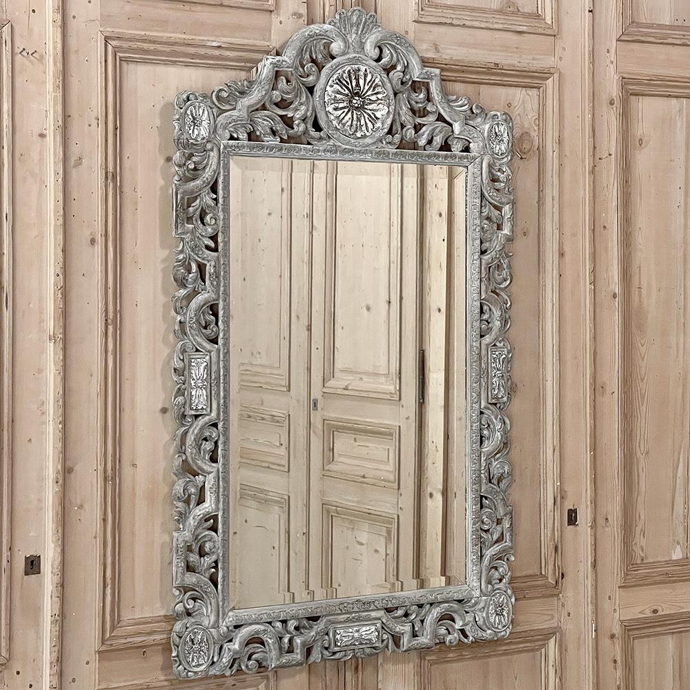 Antique Renaissance Carved and Whitewashed Wood Mirror is a glorious example of hand-sculpted artistry making it an exceptional choice for adding flair and ambiance to any room.  The framework boasts neoclassical 