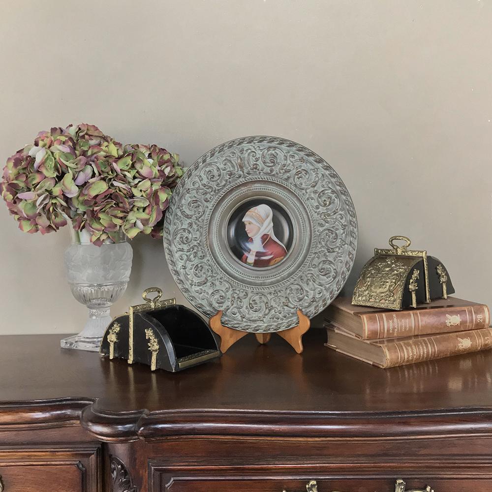 Antique Renaissance Embossed Platter with Painted Porcelain Portrait was intended purely for decoration, and features an exquisitely rendered hand-painted portrait of a lovely young (obviously affluent) maiden with vivid coloration preserved by the