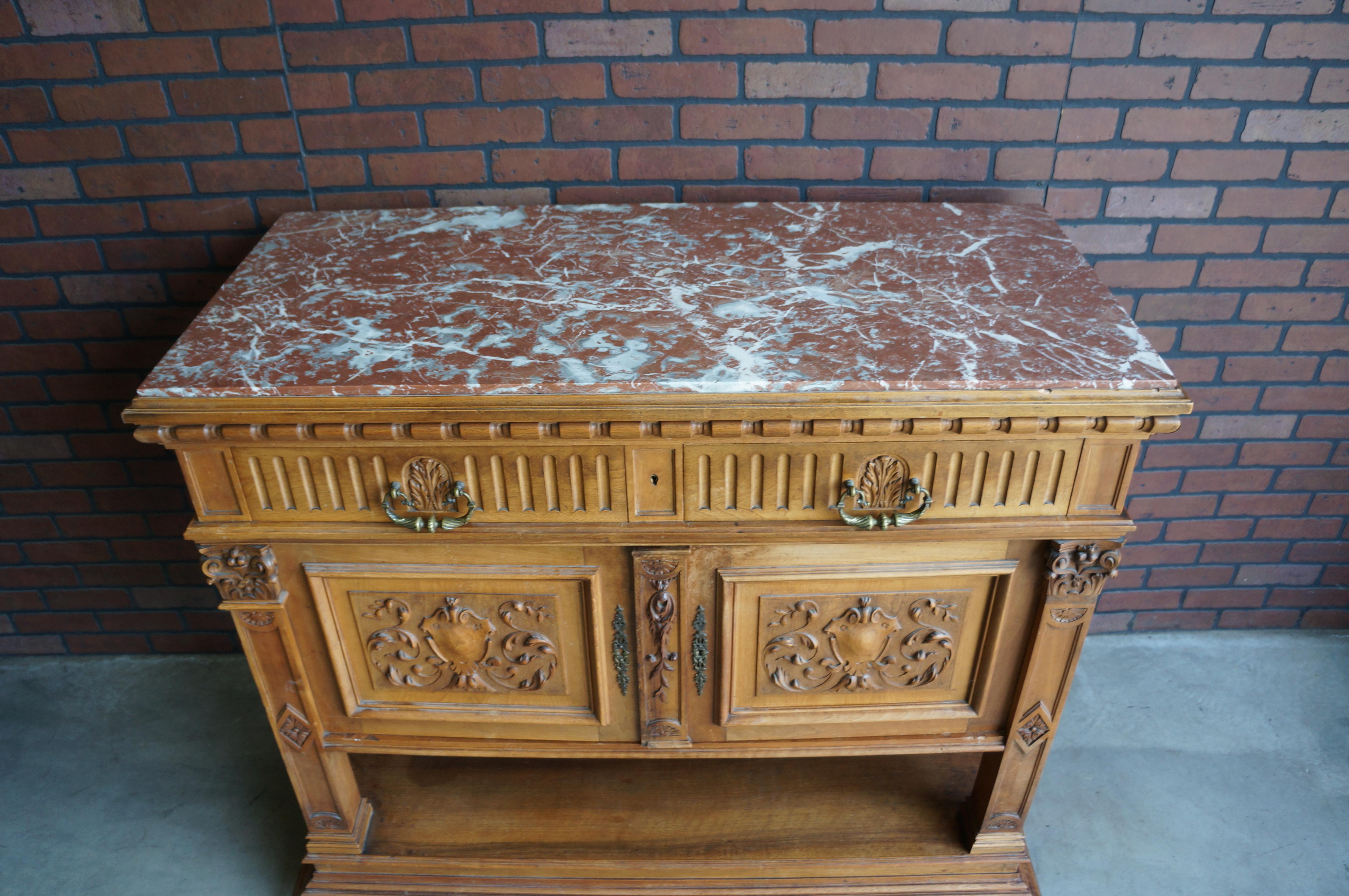 Magnificent Renaissance marble top buffet. Inspired by classic architectural details of the time. Featuring marble inset top, two drawers with cast brass drop pulls, egg and dart detail, multi-tiered base and bun feet. Two doors with exquisite
