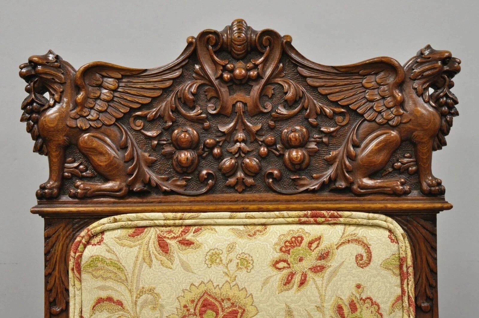 Antique Italian Renaissance Carved Oak Winged Griffin Paw Foot Dining Side Chairs Attributed to RJ Horner - a Pair. Item features harvest scroll work to top rail, upholstered back and seats, solid oak wood construction, finely carved details,
